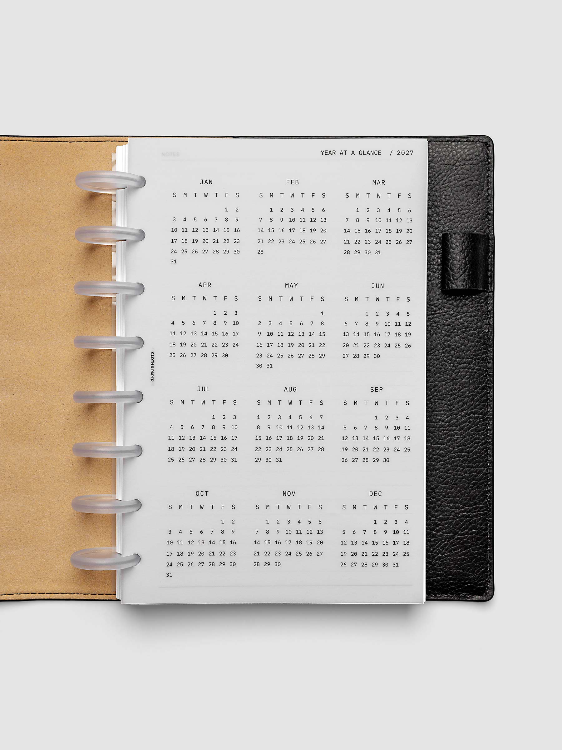 2027 Year At A Glance Dashboard Sunday Start, Half Letter 8-Disc Punch, translucent vellum year-at-a-glance calendar shown inside a planner
