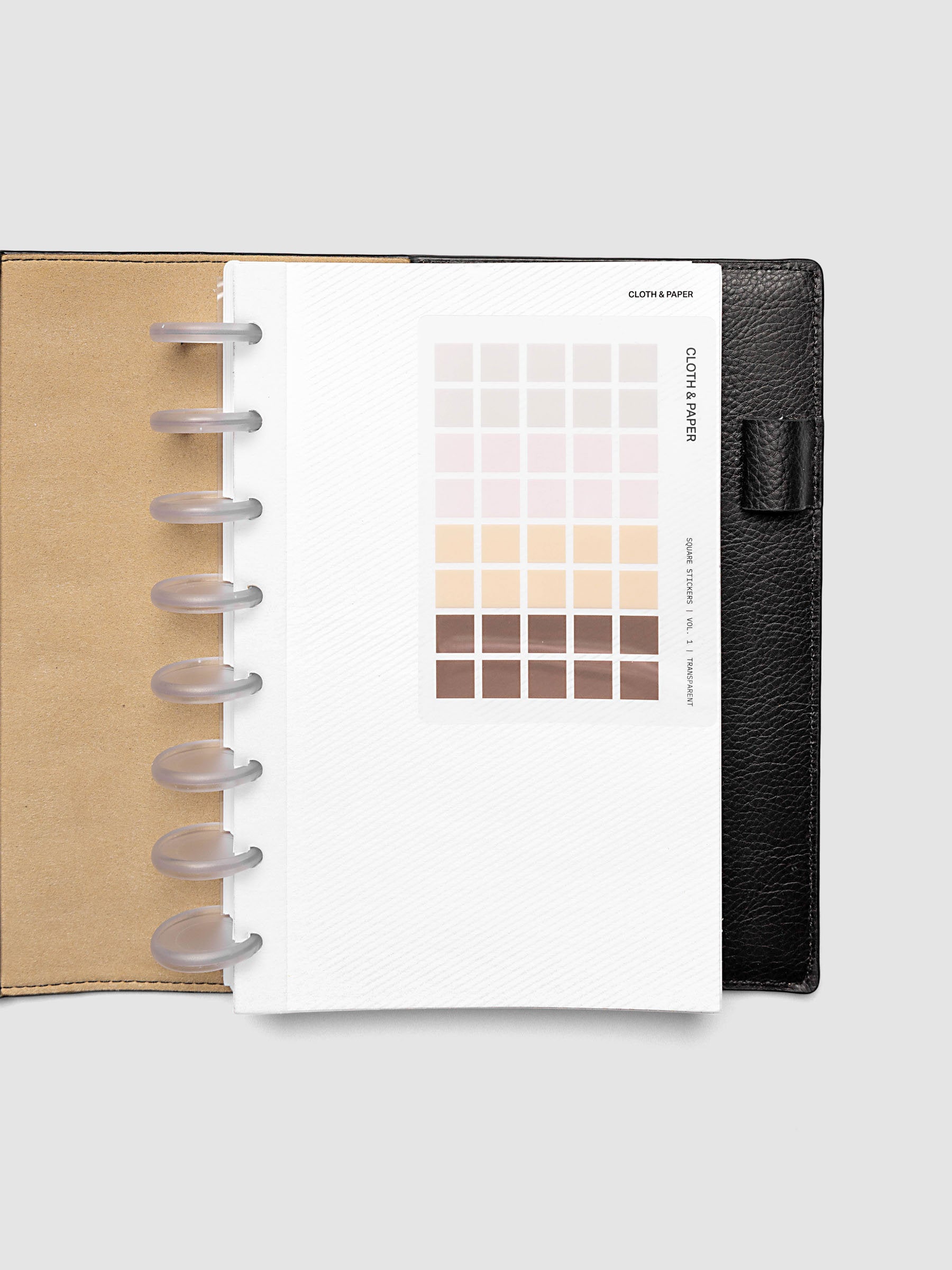 Folded Collage Planner Dashboard, Half Letter 8-Disc Punch, stickers affixed to the adhesive surface of the open dashboard