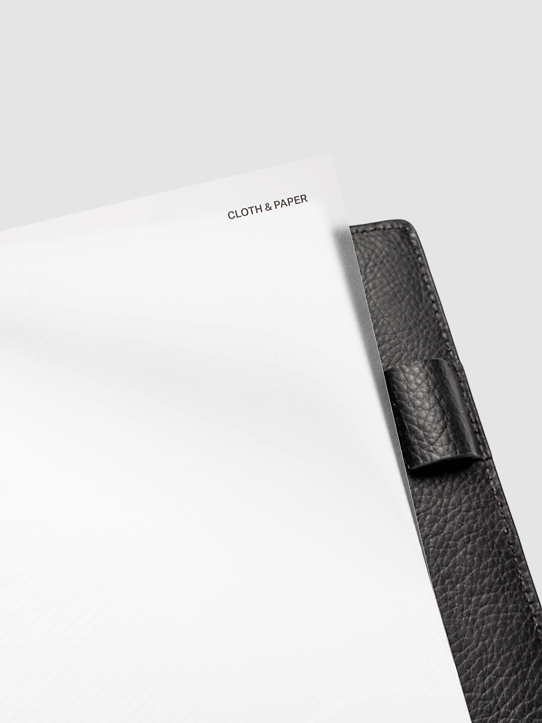 Folded Collage Planner Dashboard, Half Letter 8-Disc Punch, close-up detail showing the top clear plastic layer lifted at the right corner