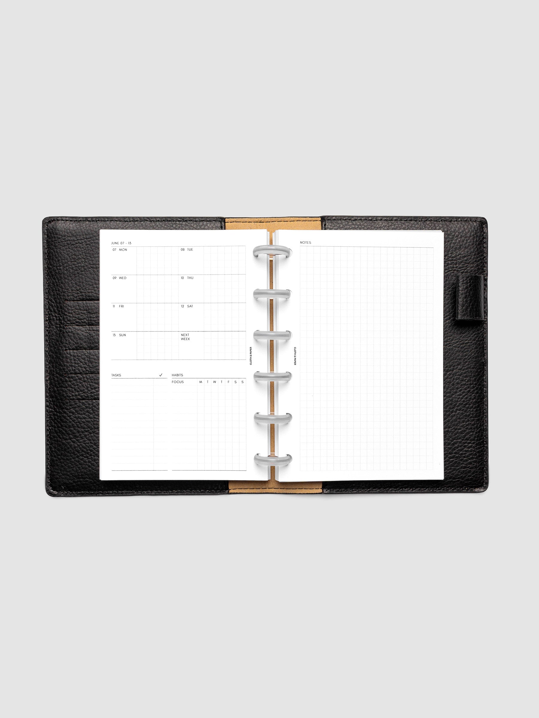 Open planner showing the full two-page 2027 Dated Weekly Admin spread in CP Petite 6-Disc Punch size, with the weekly overview and task and habit tracking sections on the left and a graph notes layout on the right