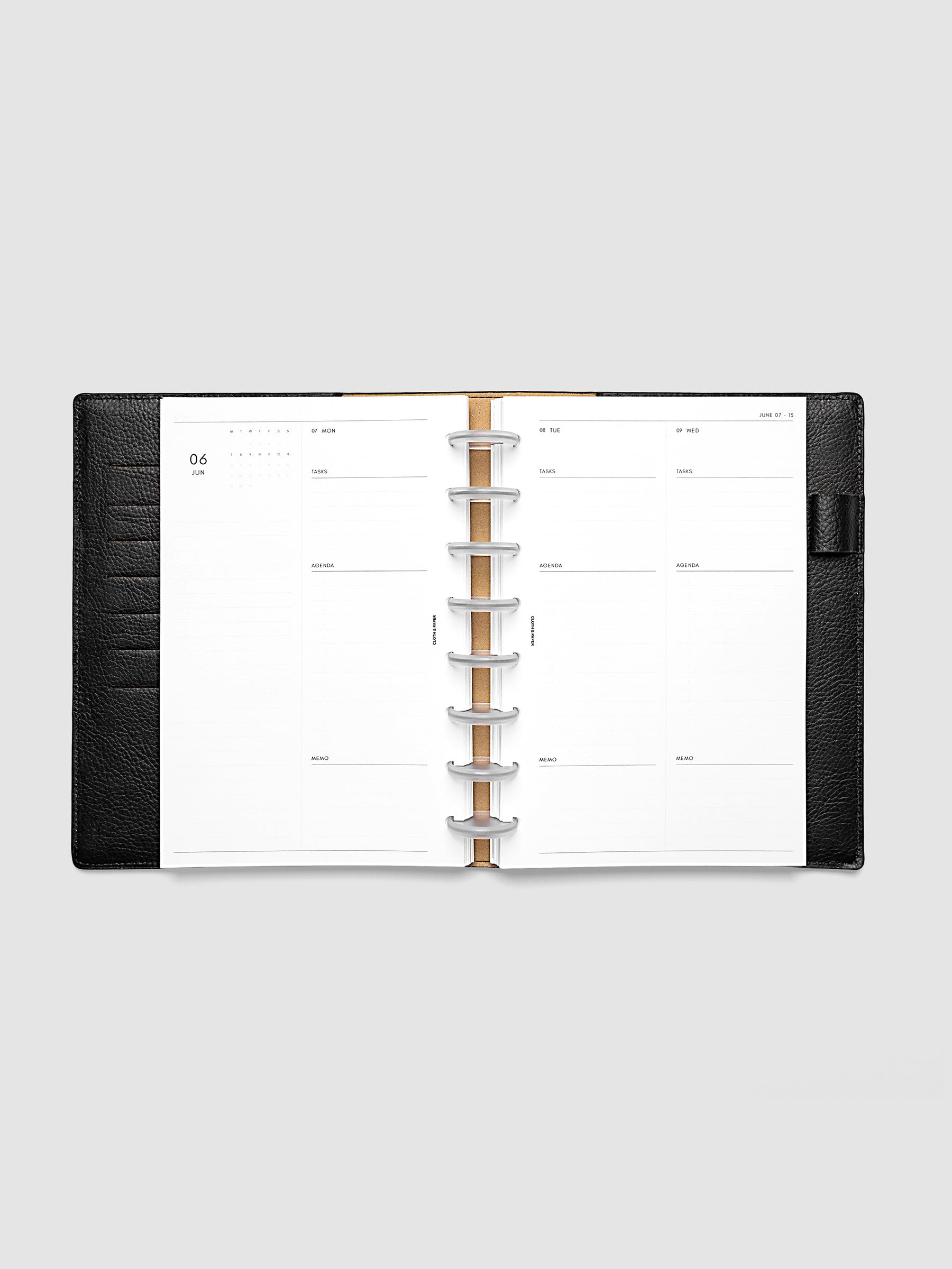 2027 Dated Daily Inserts | Monday Start in size Half Letter 8-Disc Punch inside a black planner cover