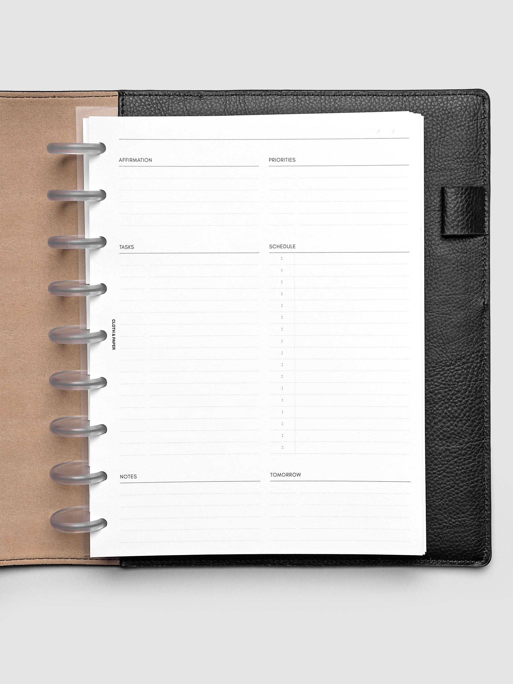 Daily Essentials Planner Inserts shown in size HP Classic inside a black folio.