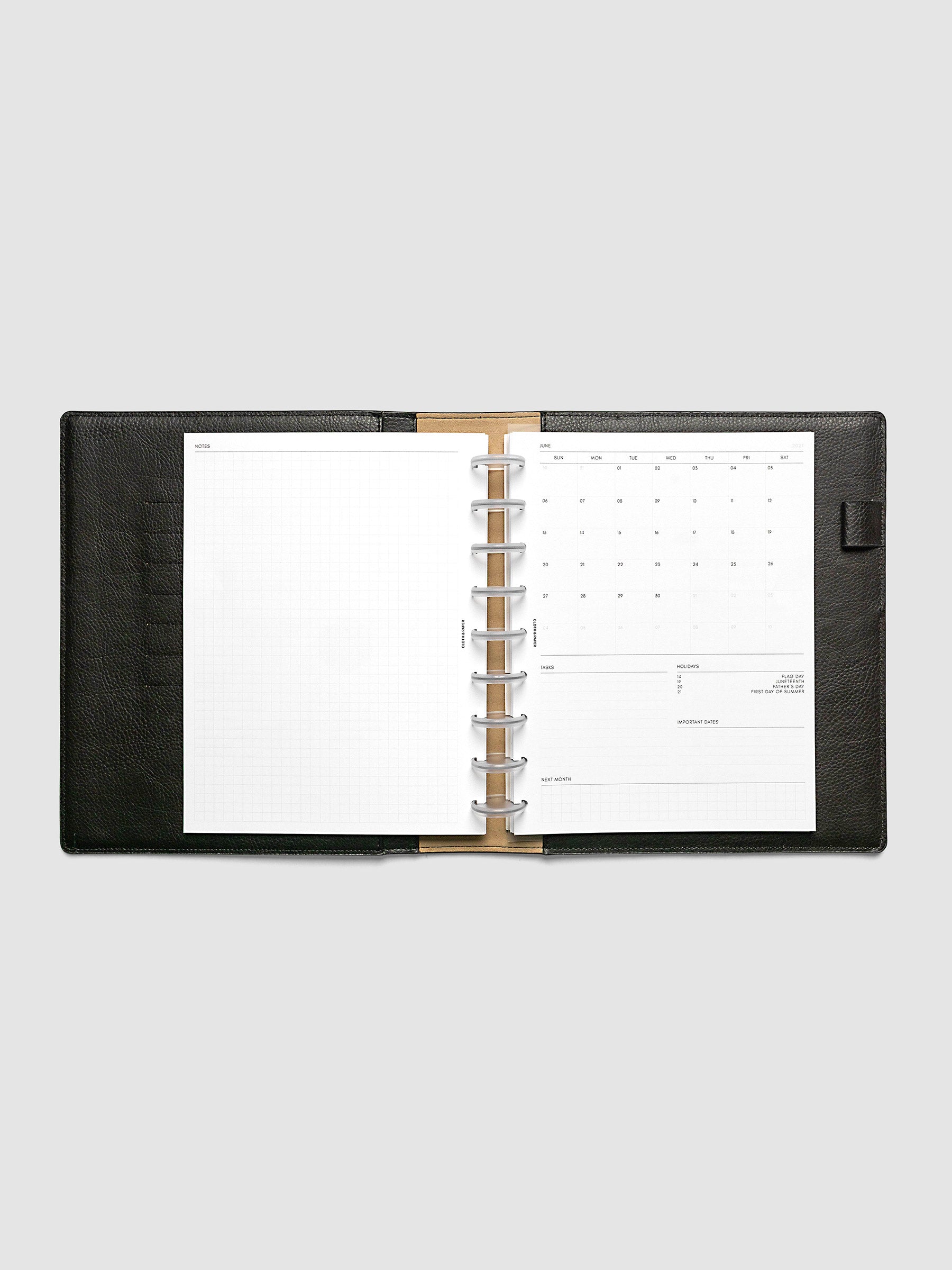 2027 Dated Monthly Admin Inserts open inside a HP Classic 9-Disc Punch discbound planner, showing the fully open graph left page alongside the Sunday start monthly calendar, task section, holiday reference, important dates, and next month preview on the right.