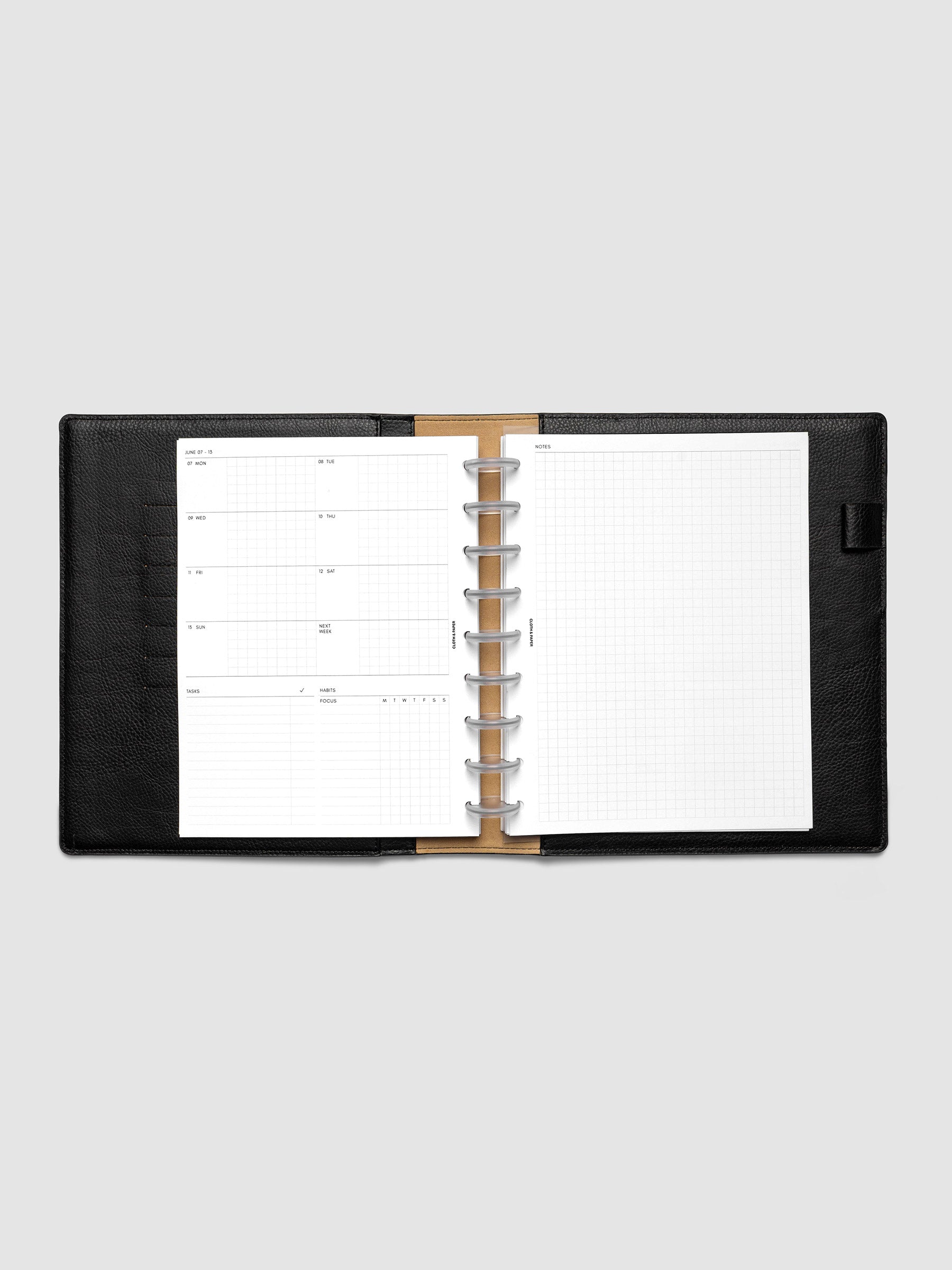 Open planner showing the full two-page 2027 Dated Weekly Admin spread in HP Classic 9-Disc Punch size, with the weekly overview and task and habit tracking sections on the left and a graph notes layout on the right