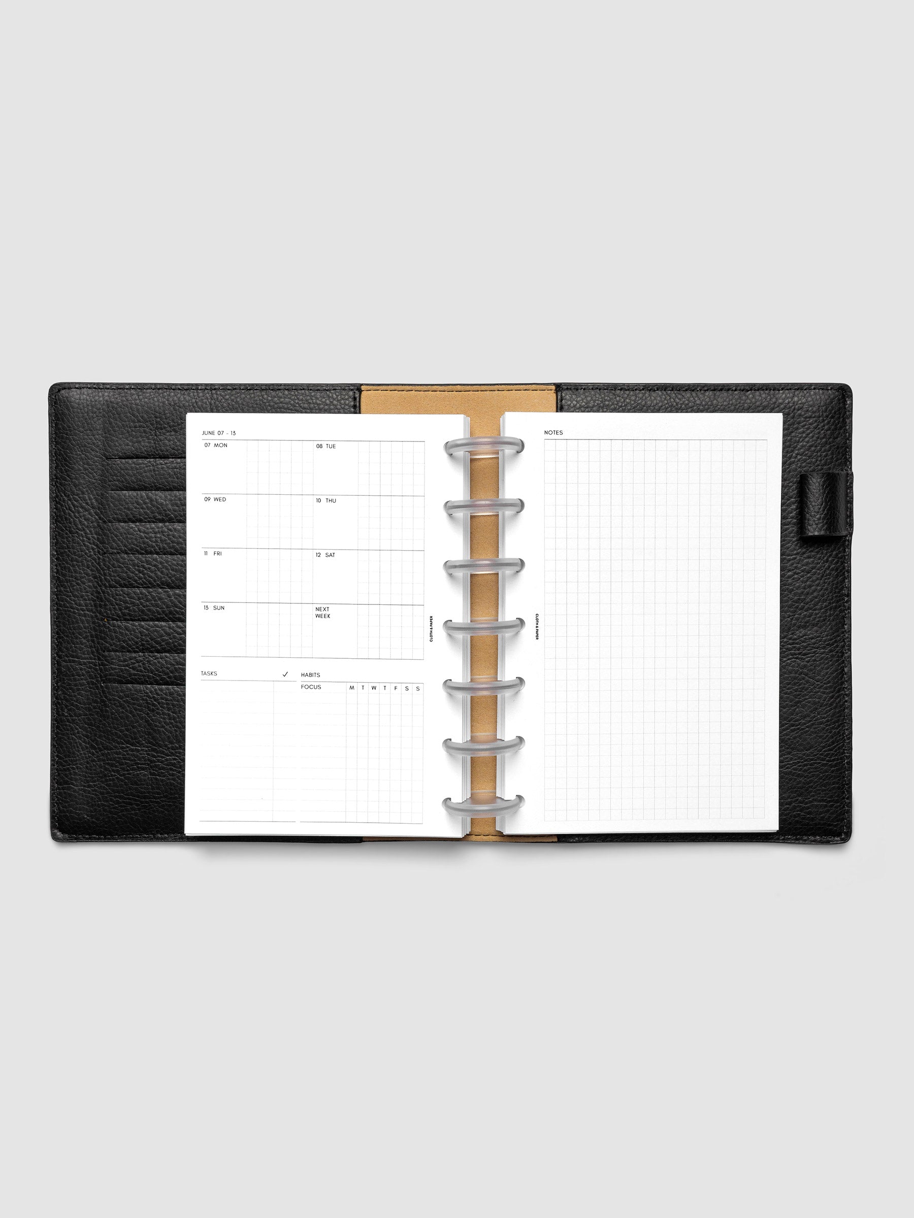 Open planner showing the full two-page 2027 Dated Weekly Admin spread in HP Mini 7-Disc Punch size, with the weekly overview and task and habit tracking sections on the left and a graph notes layout on the right