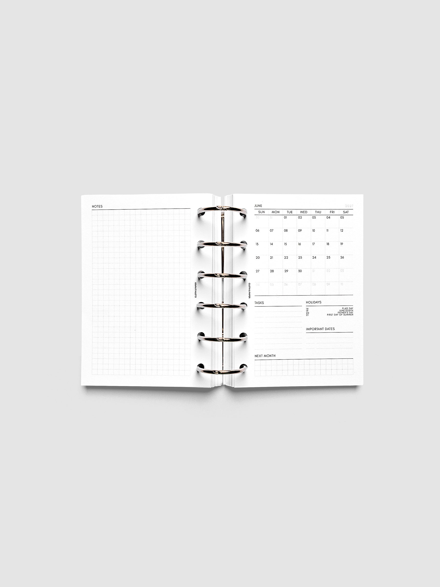2027 Dated Monthly Admin Inserts open inside a Pocket 6-Ring Punch 6-ring planner, showing the fully open graph left page alongside the Sunday start monthly calendar, task section, holiday reference, important dates, and next month preview on the right.