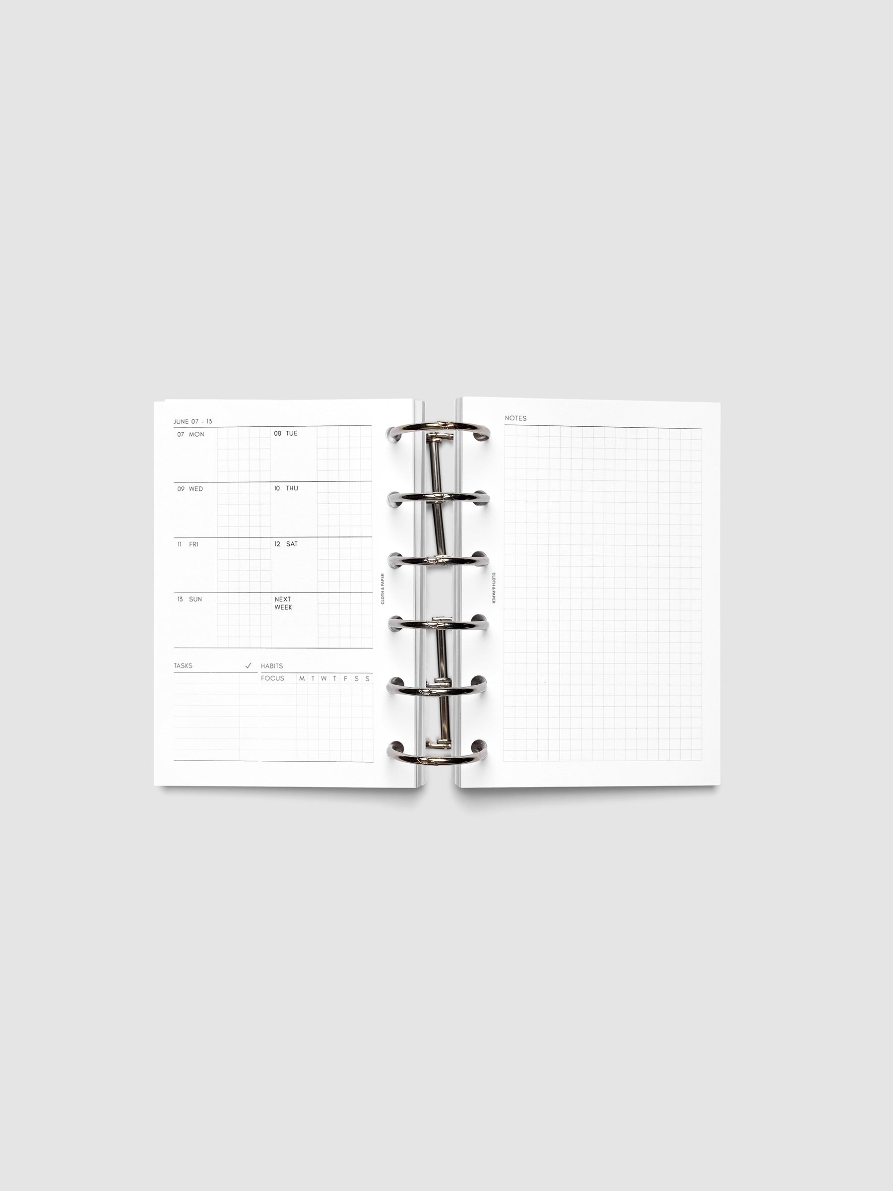 Open planner showing the full two-page 2027 Dated Weekly Admin spread in Pocket 6-Ring Punch size, with the weekly overview and task and habit tracking sections on the left and a graph notes layout on the right