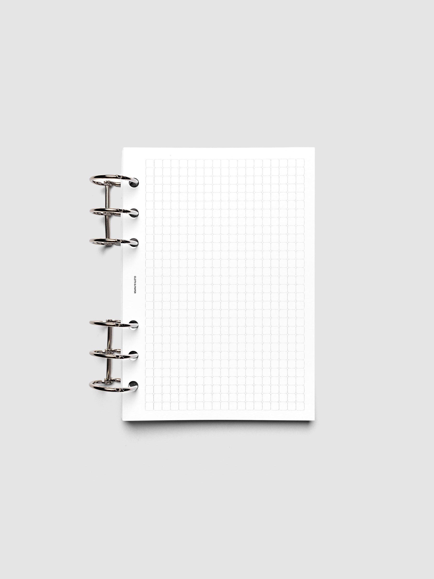 Rounded Graph Planner Insert Personal Wide 6-Ring Punch open to an unused grid page