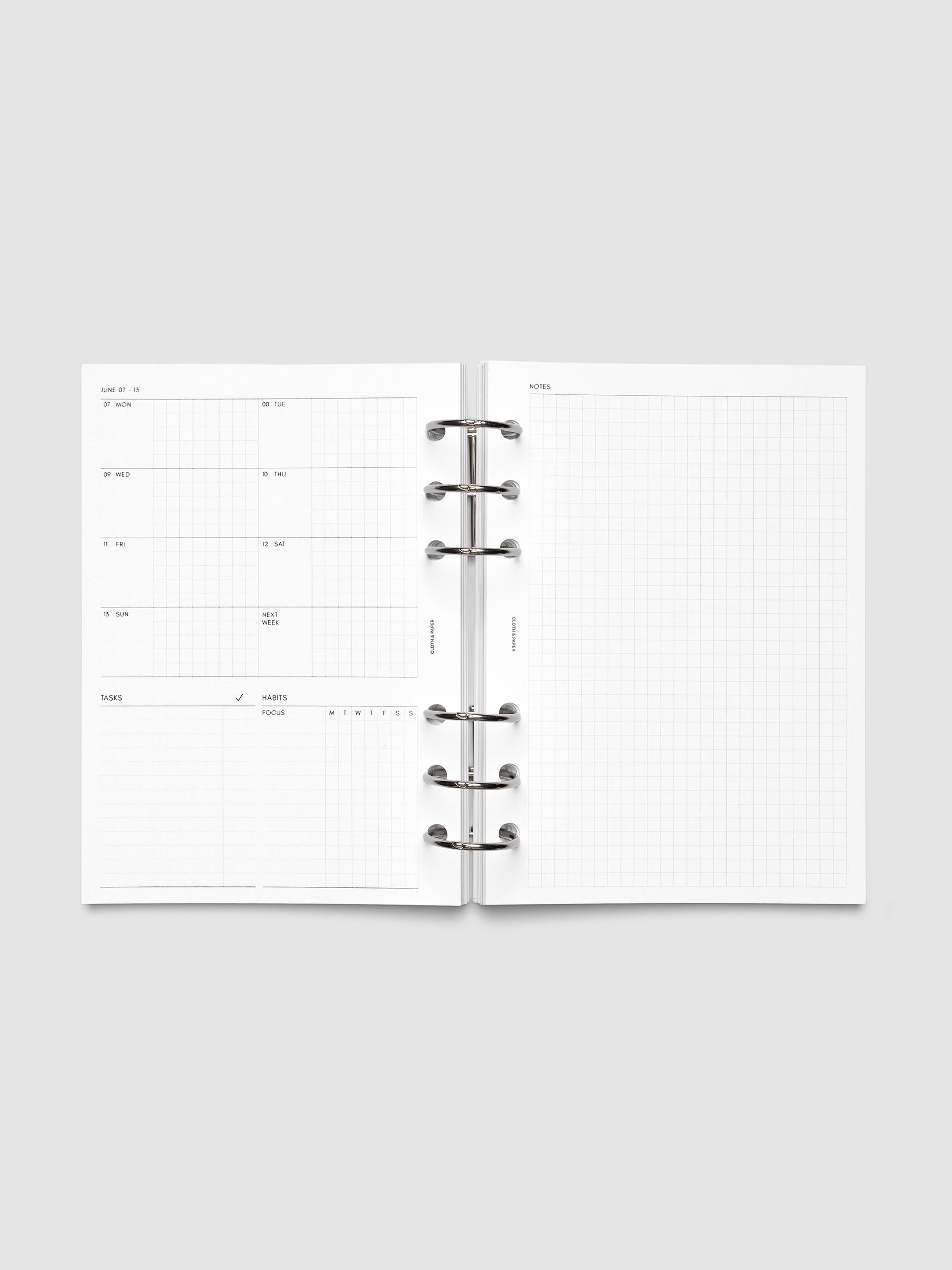 Open planner showing the full two-page 2027 Dated Weekly Admin spread in Personal Wide 6-Ring Punch size, with the weekly overview and task and habit tracking sections on the left and a graph notes layout on the right