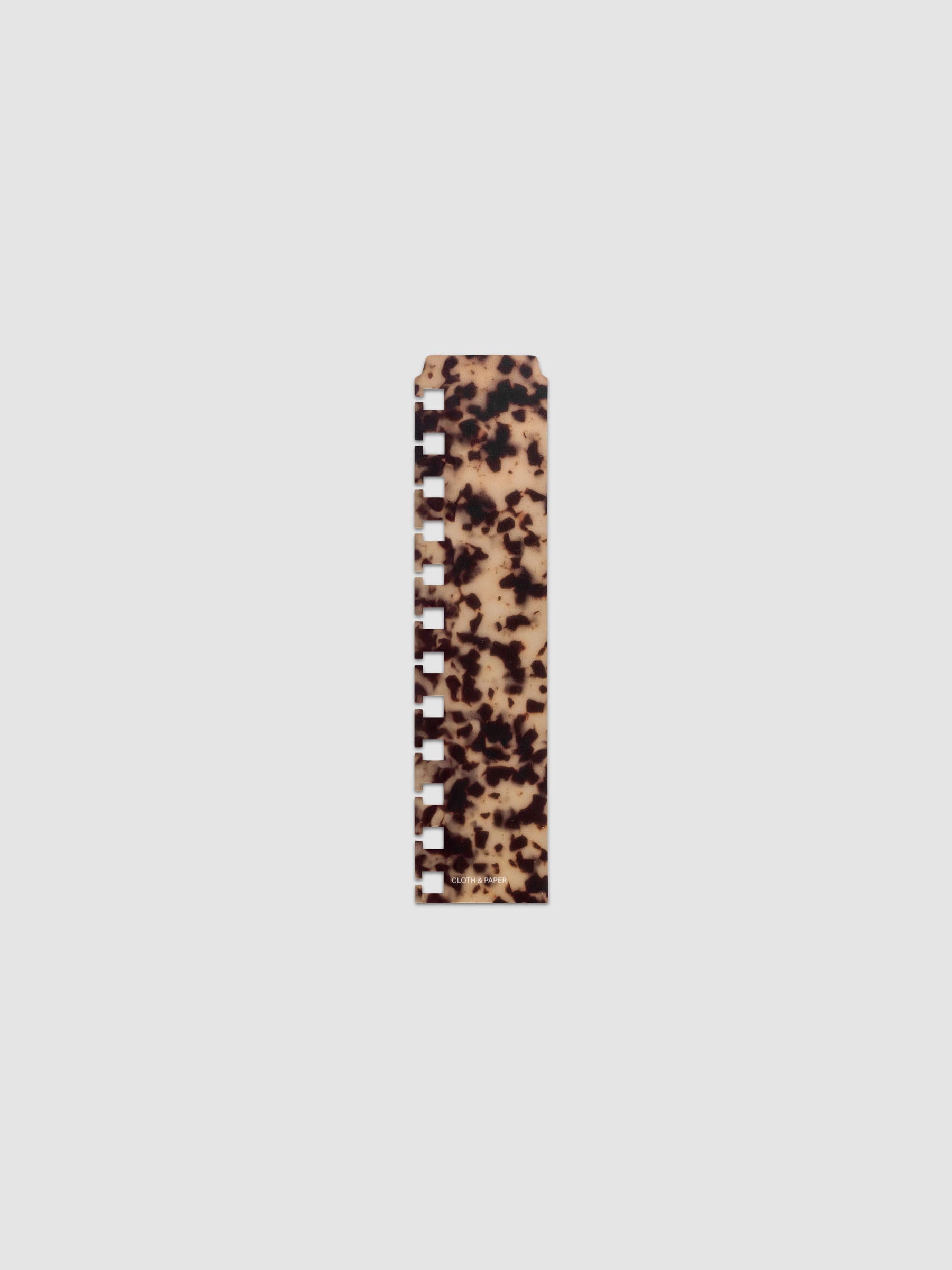 One narrow page marker in tortoiseshell pattern, shown in size CP Petite Spiral.
