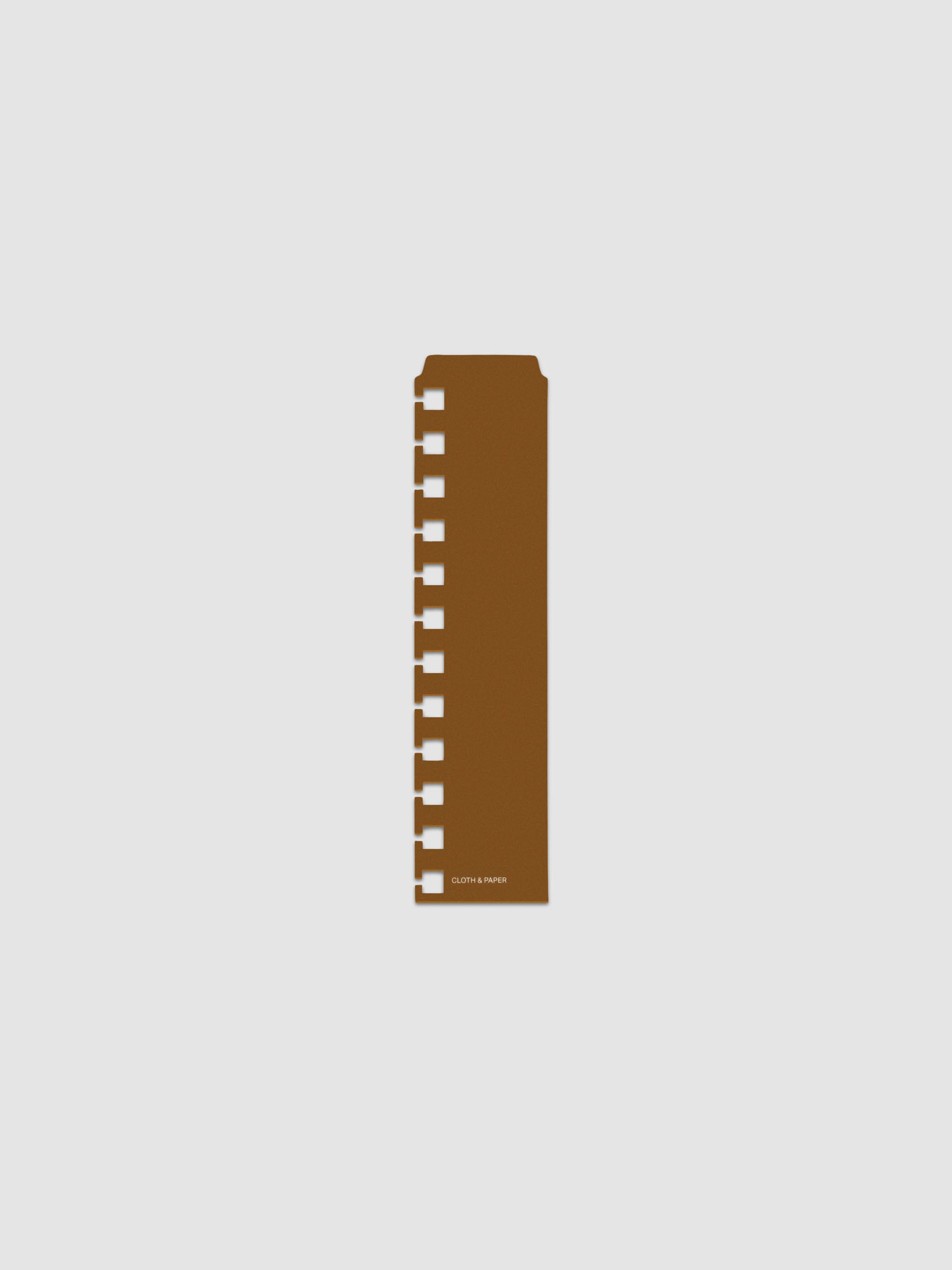 One narrow page marker in brown, shown in size CP Petite Spiral.