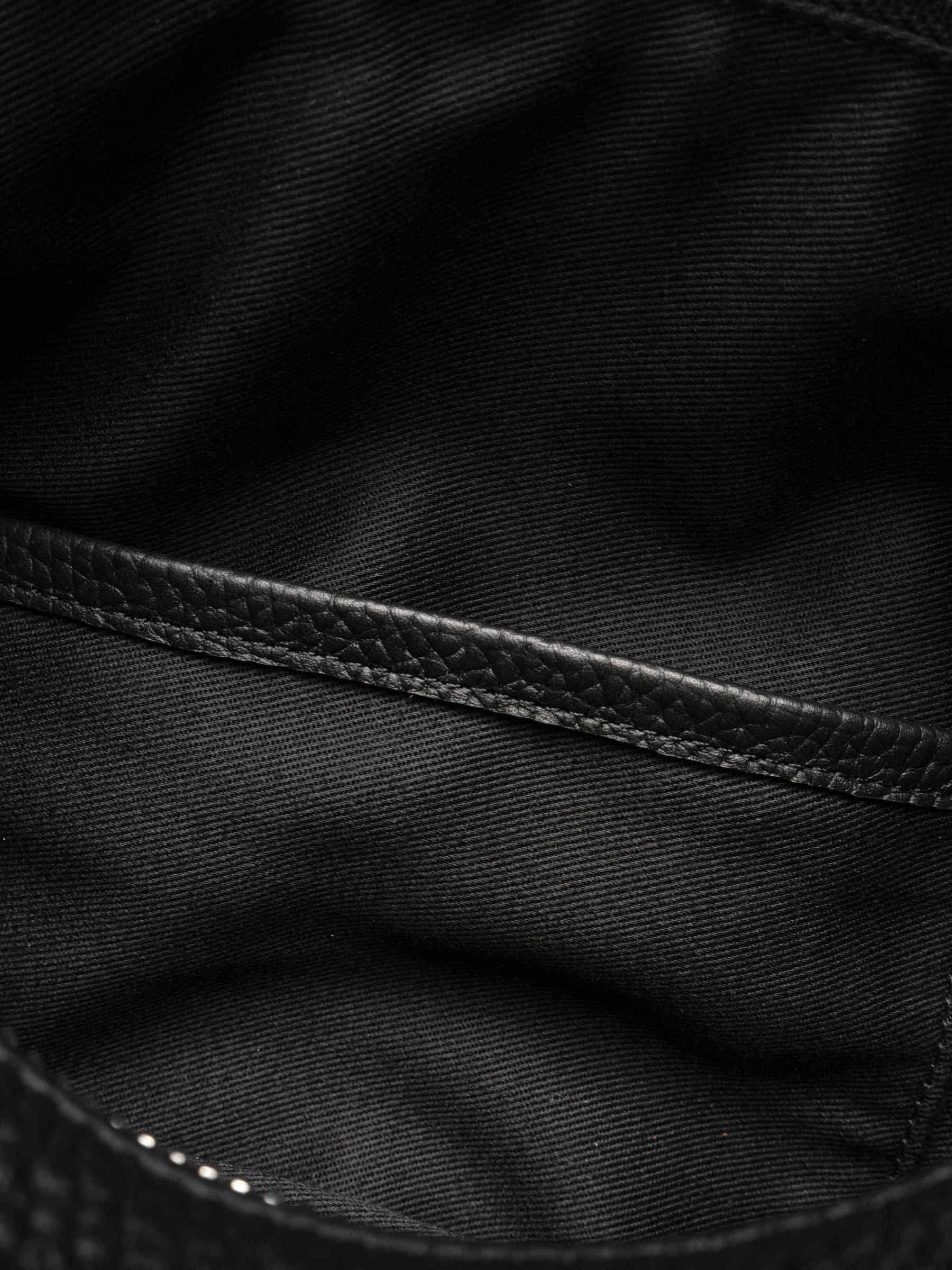 Folded Form Pouch interior close-up showing fabric lining and leather-trimmed interior side pocket