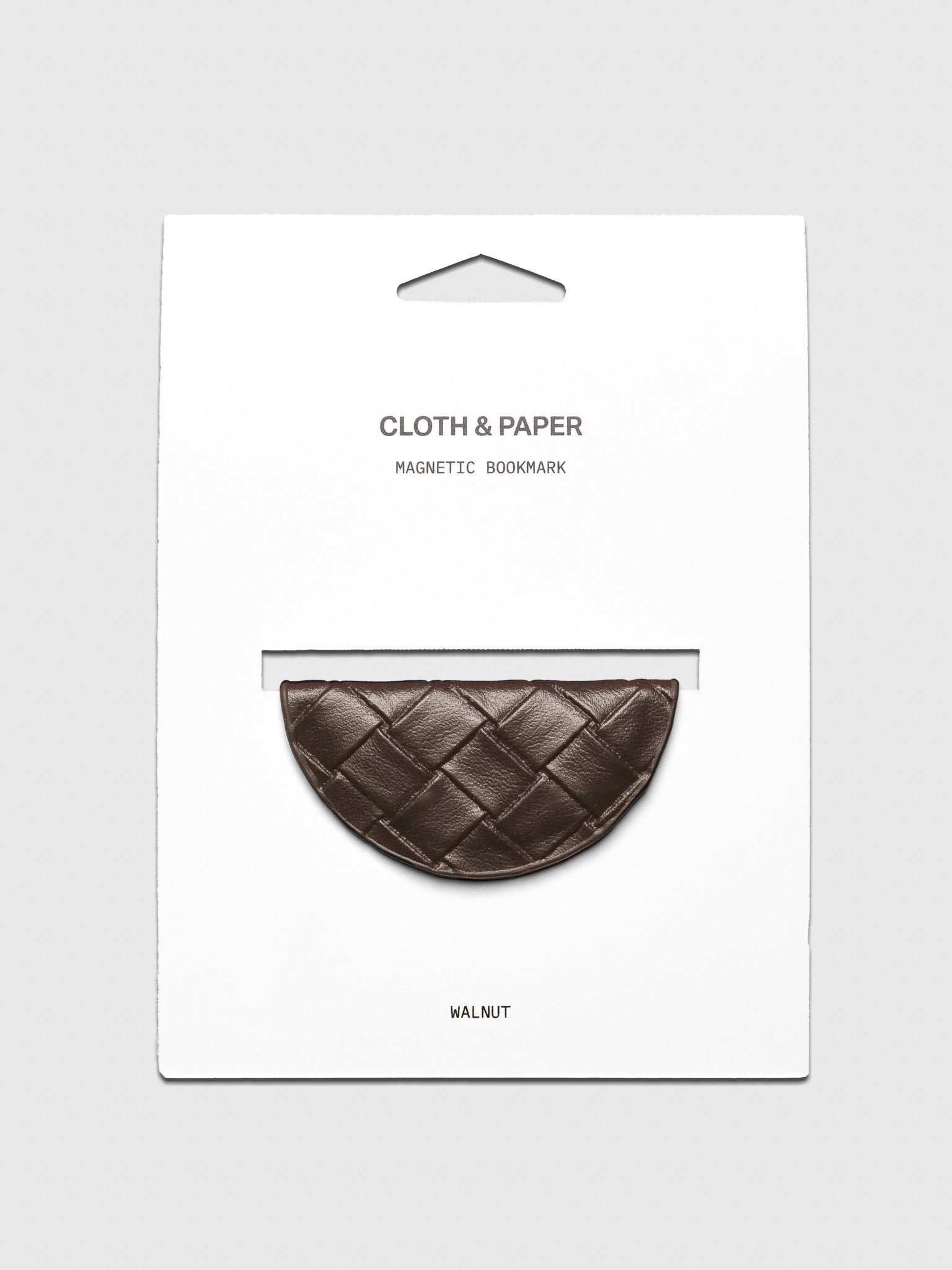 Woven vegan leather magnetic bookmark in the color walnut shown on a backing card.