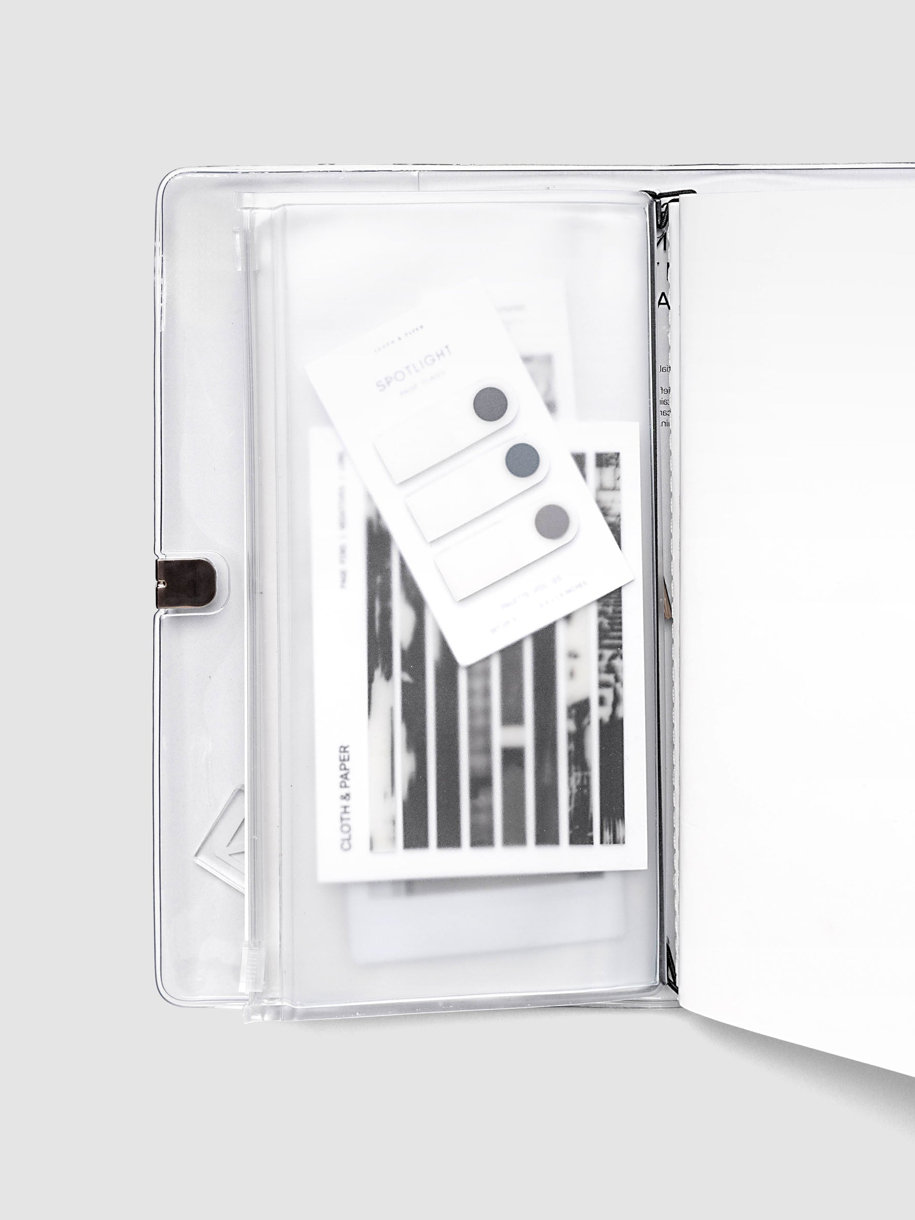 Storage Holder Travel Notebook A5 Slim tucked inside an open travel notebook cover with page pins visible through frosted plastic