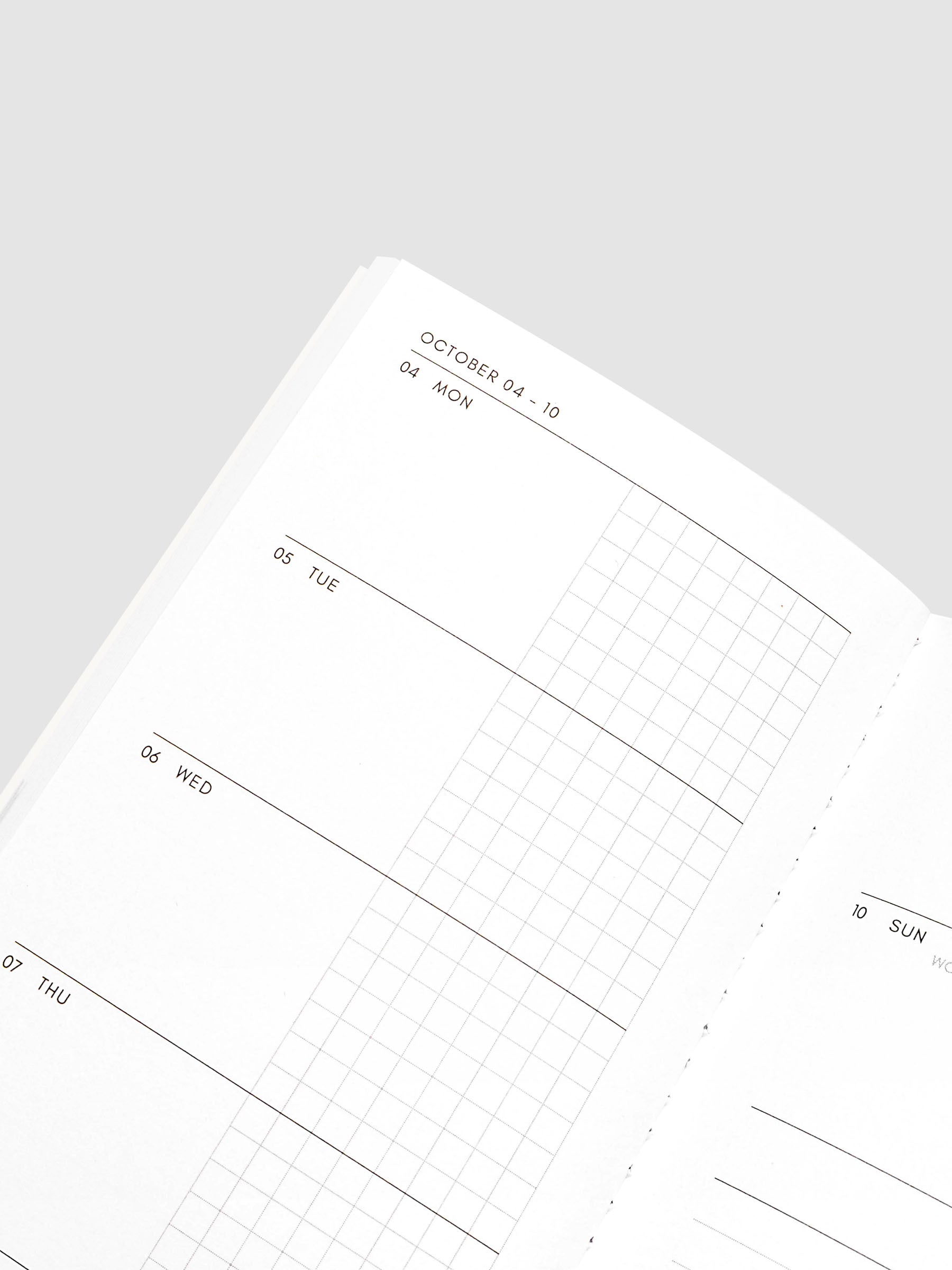 Close-up of the top of the left page of the Jul–Dec 2027 Dated Travel Notebook, showing the split daily columns with open space and graph sections