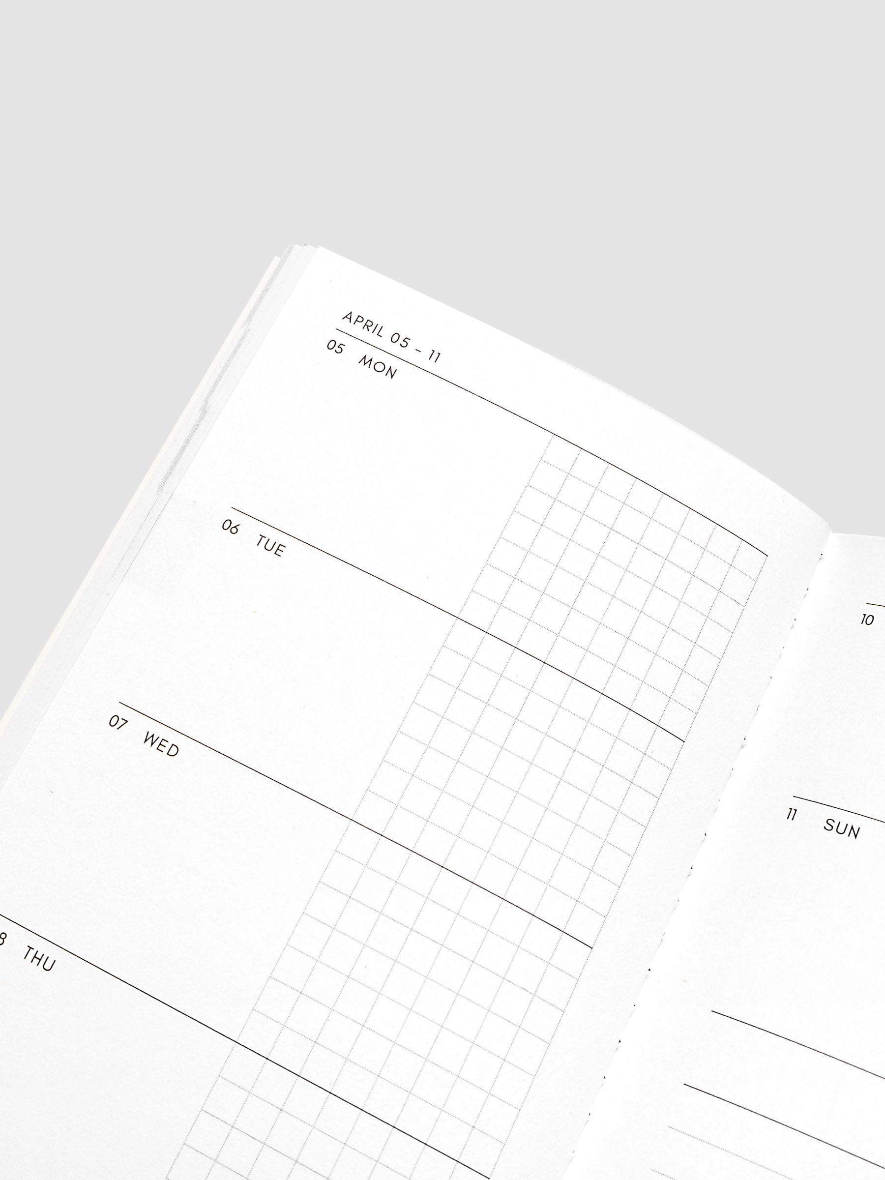 Close-up of the top of the left page of the Jan–Jun 2027 Dated Travel Notebook, showing the split daily columns with open space and graph sections