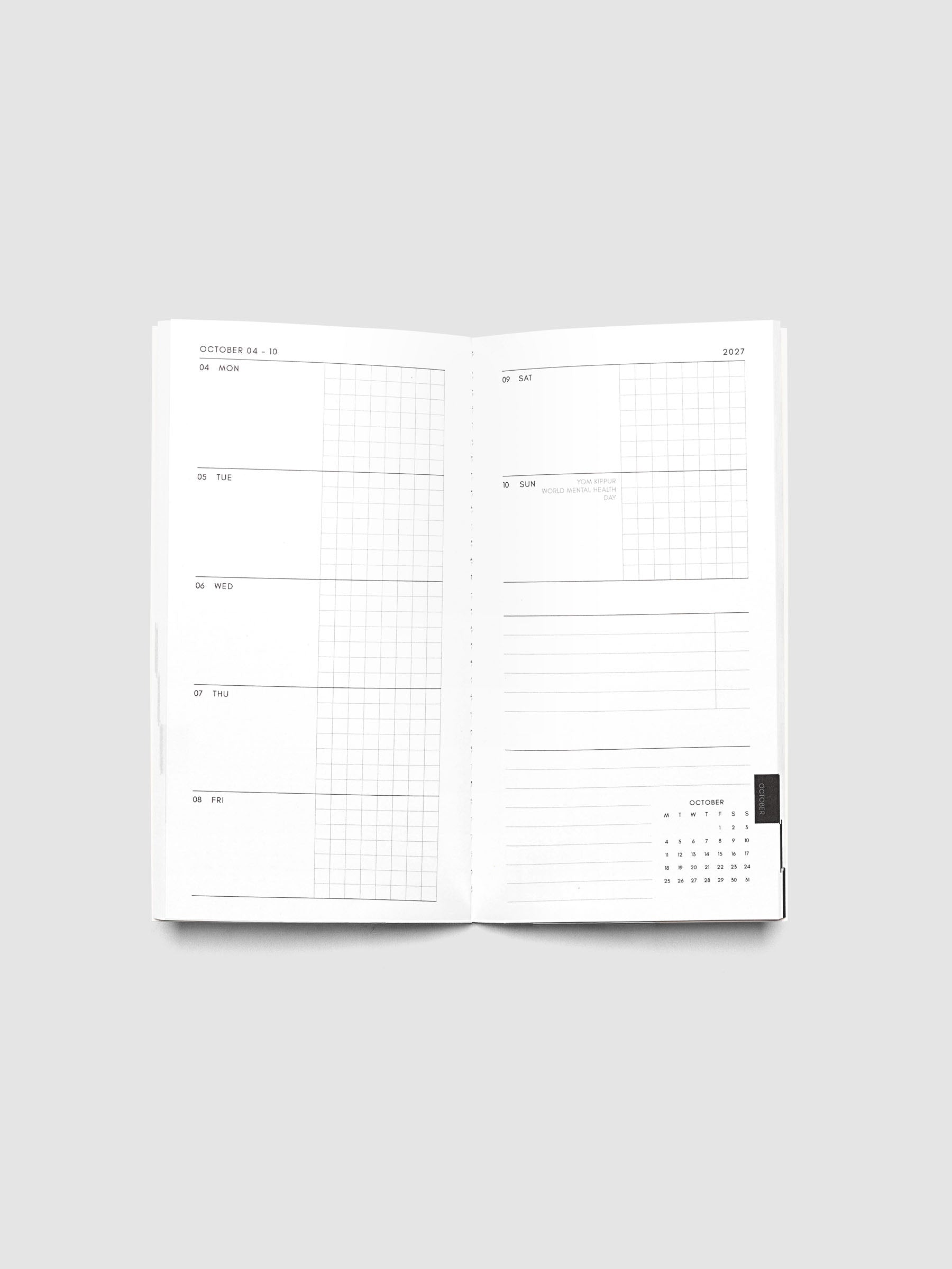 Open Jul–Dec 2027 Dated Travel Notebook showing the full weekly spread, with split daily columns on the left page and weekend dates, task section, notes section, and month-at-a-glance on the right