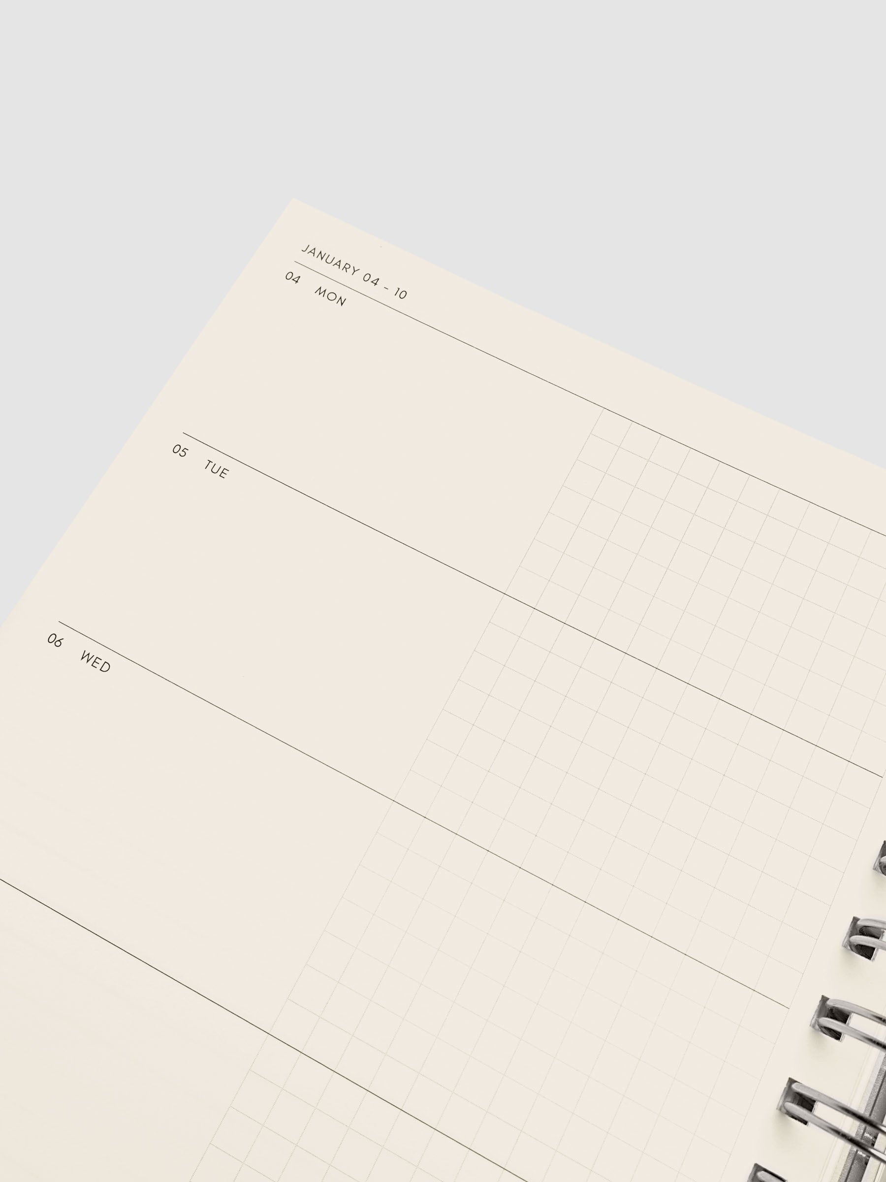 Close-up of the top left of the horizontal weekly spread showing the half-blank, half-graph daily section layout, from the 2026–2027 Weekly Horizontal Academic Planner A5 Spiral
