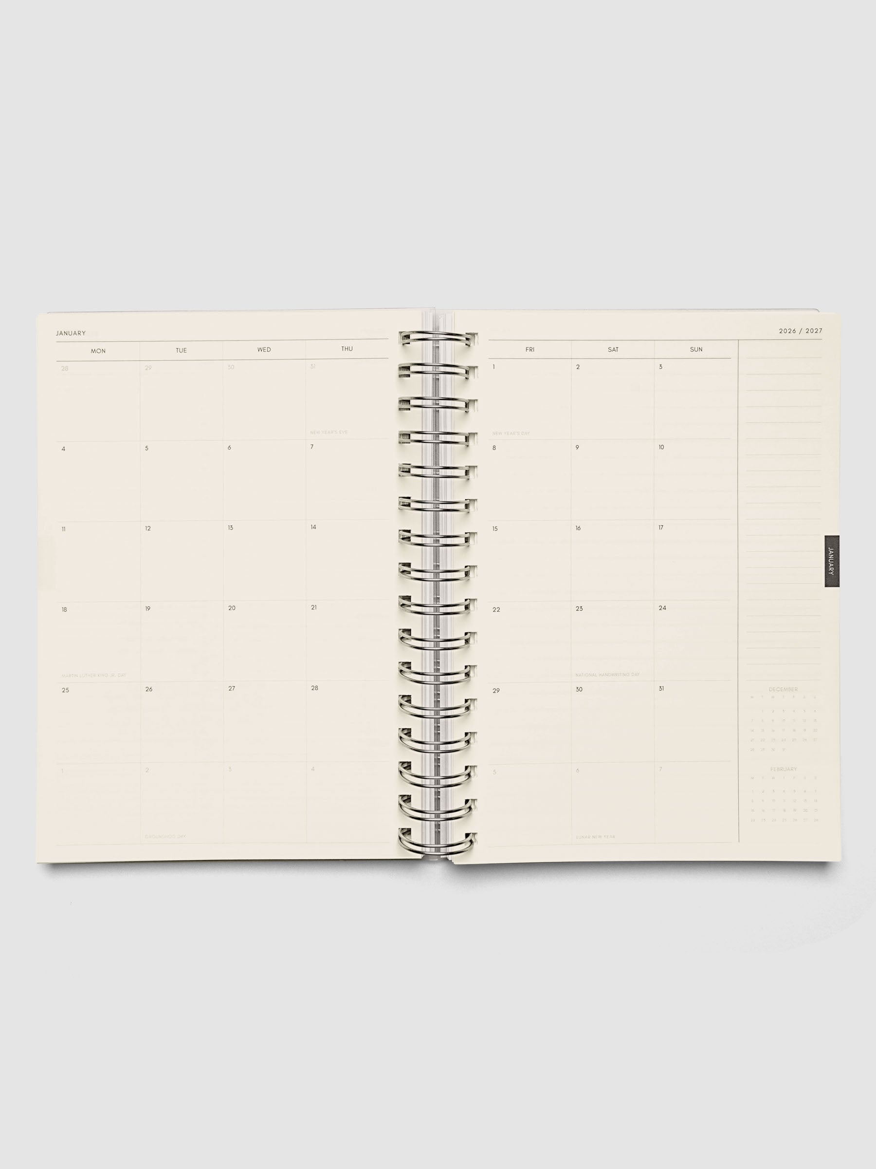 Two-page monthly calendar spread with holidays marked and previous and next month mini calendars in the bottom right corner, from the 2026–2027 Weekly Horizontal Academic Planner A5 Spiral