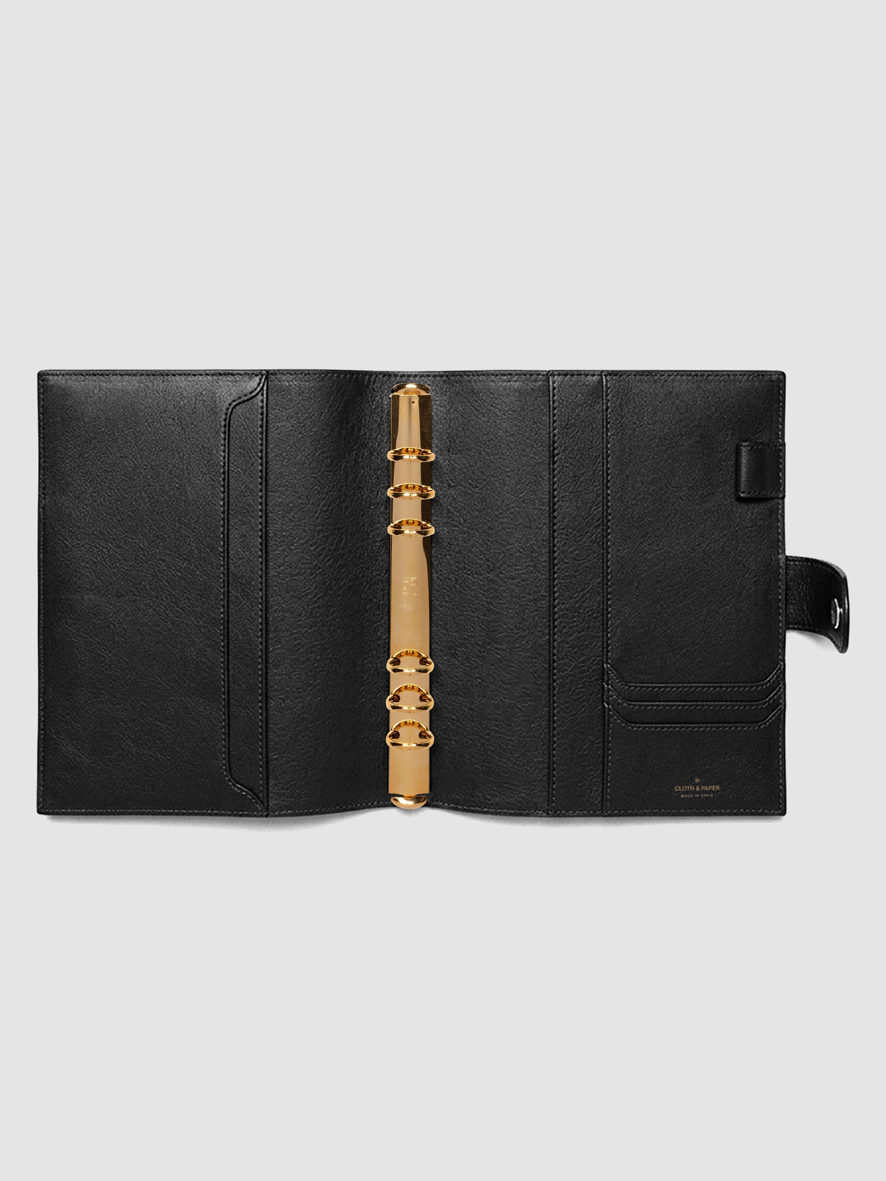 Open black genuine leather A5 6-ring planner cover showing full interior, gold Krause rings and pockets visible on both sides