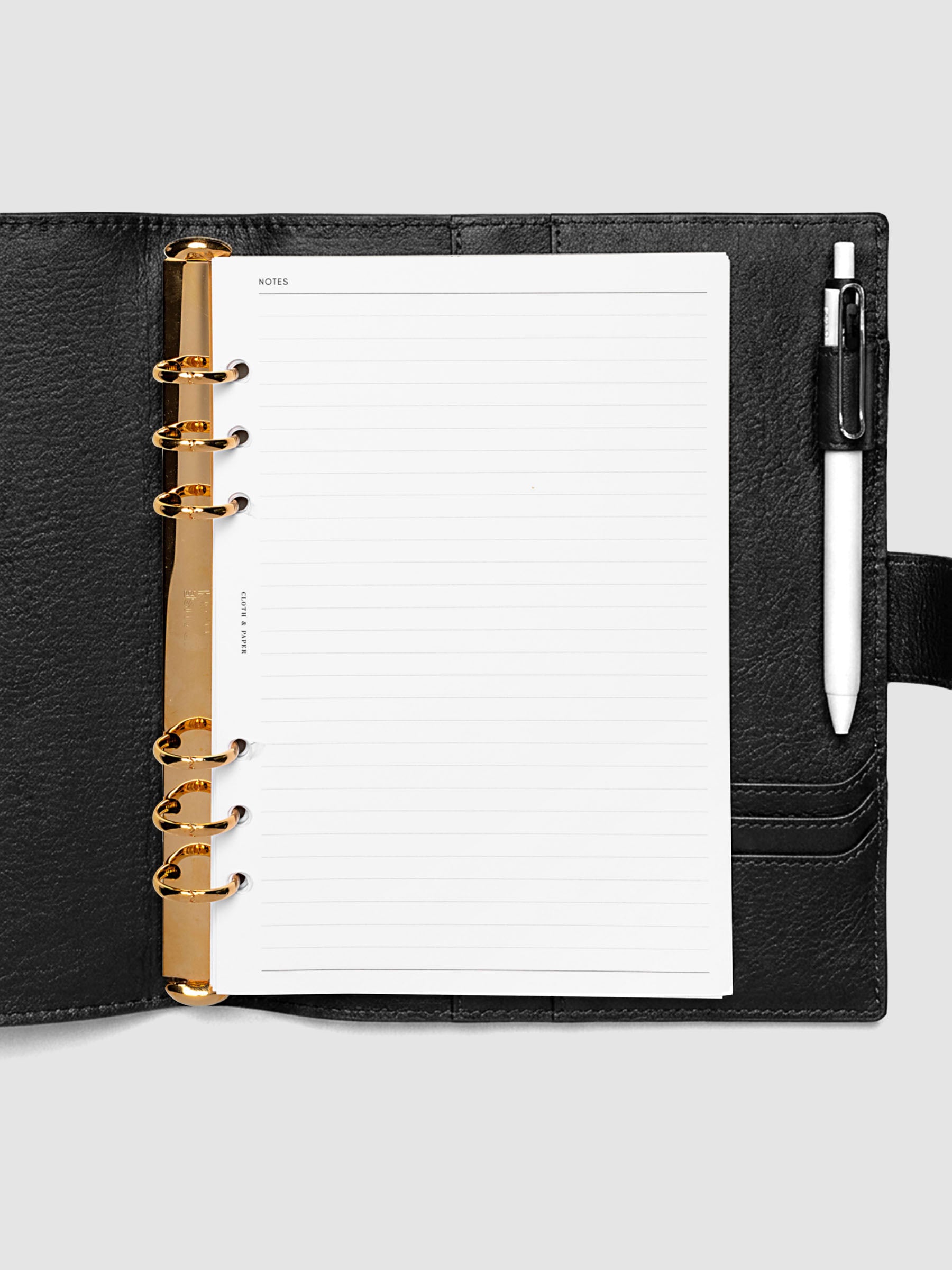 Open black genuine leather A5 6-ring planner cover with inserts inside, gold Krause rings visible