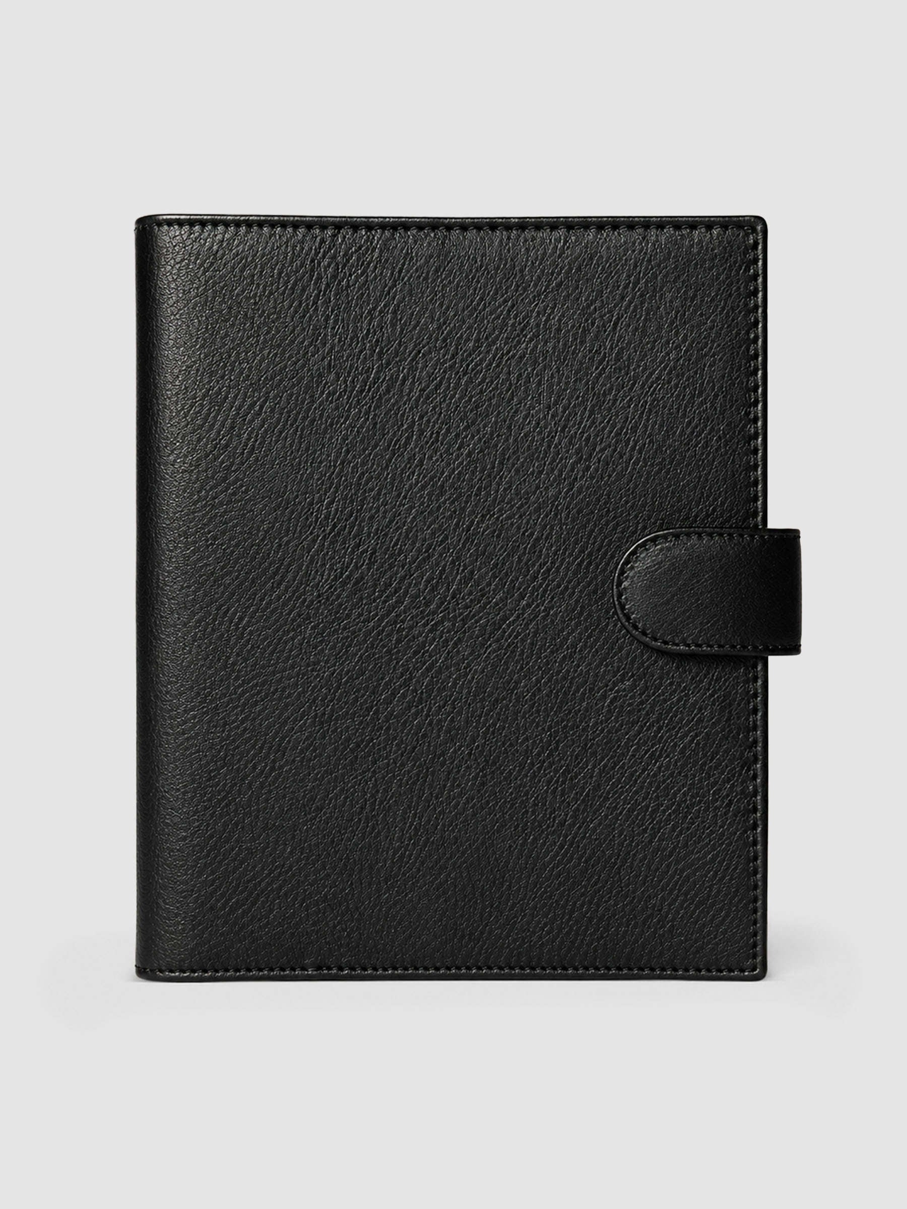 Black genuine leather A5 6-ring planner cover with gold magnetic snap closure, closed front view