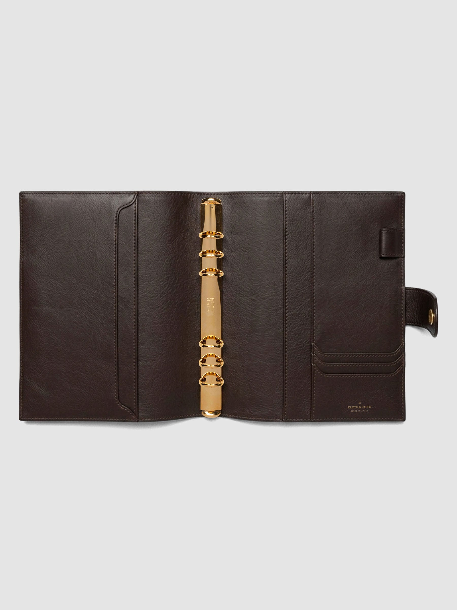Open dark brown genuine leather A5 6-ring planner cover showing full interior, gold Krause rings and pockets visible on both sides