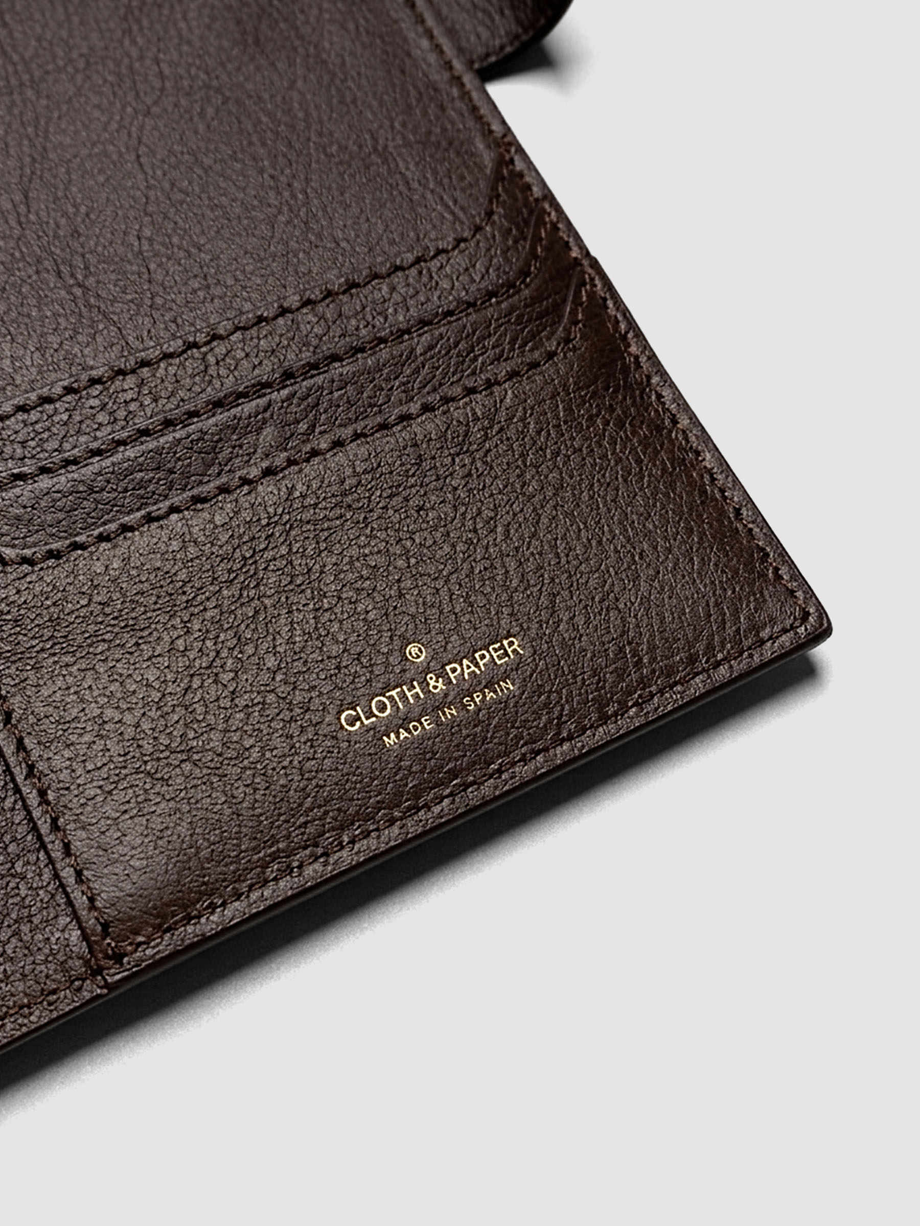 Detail of three credit card slots on the right interior of a dark brown genuine leather A5 planner cover