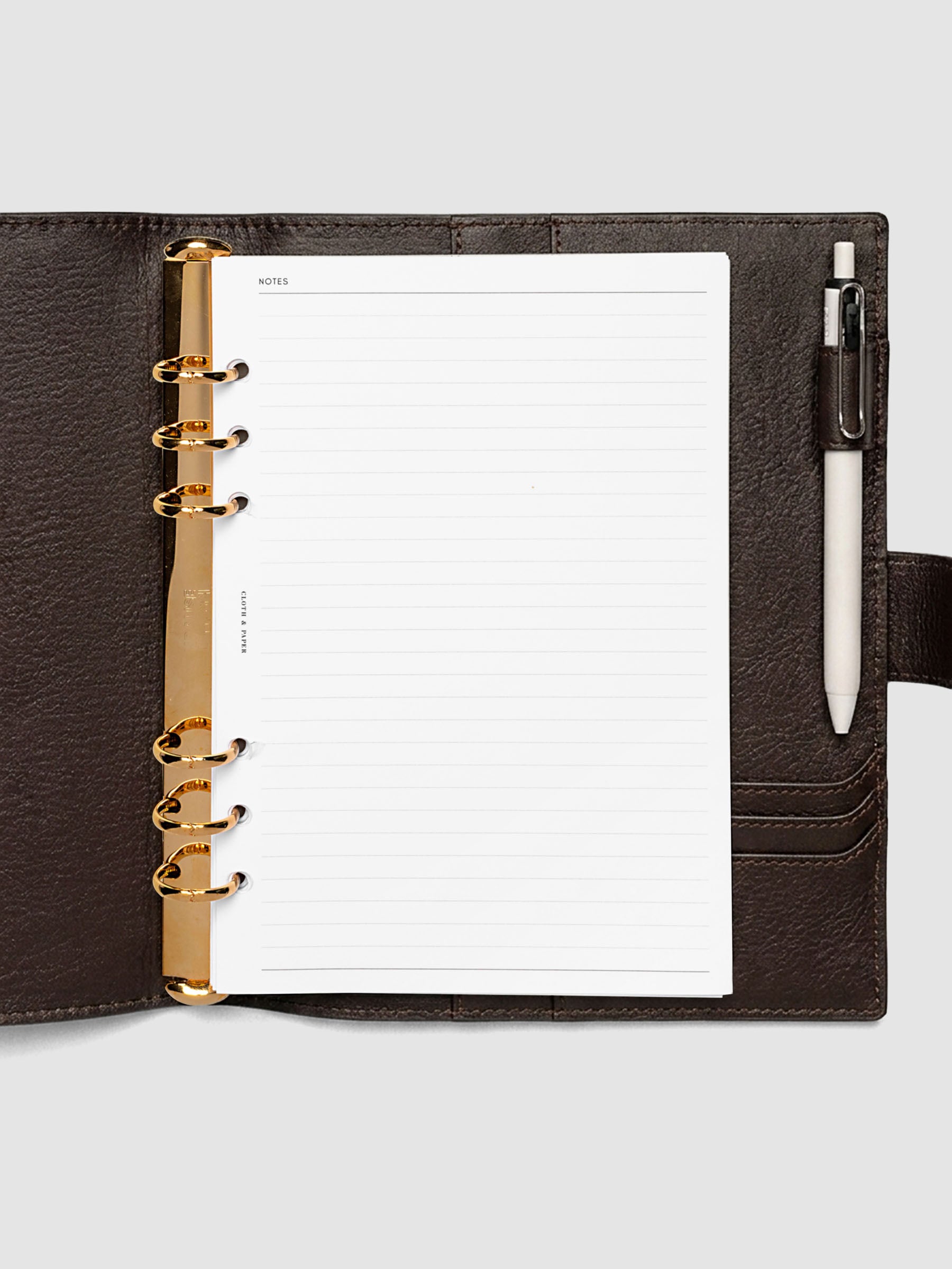 Open dark brown genuine leather A5 6-ring planner cover with inserts inside, gold Krause rings visible