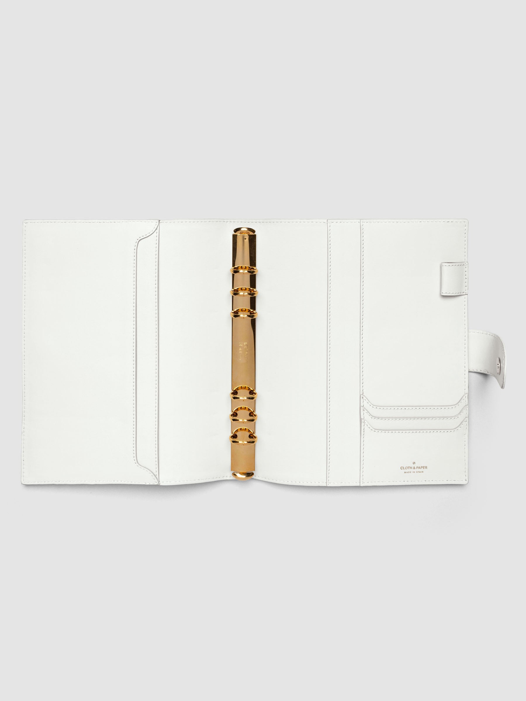 Open off-white genuine leather A5 6-ring planner cover showing full interior, gold Krause rings and pockets visible on both sides