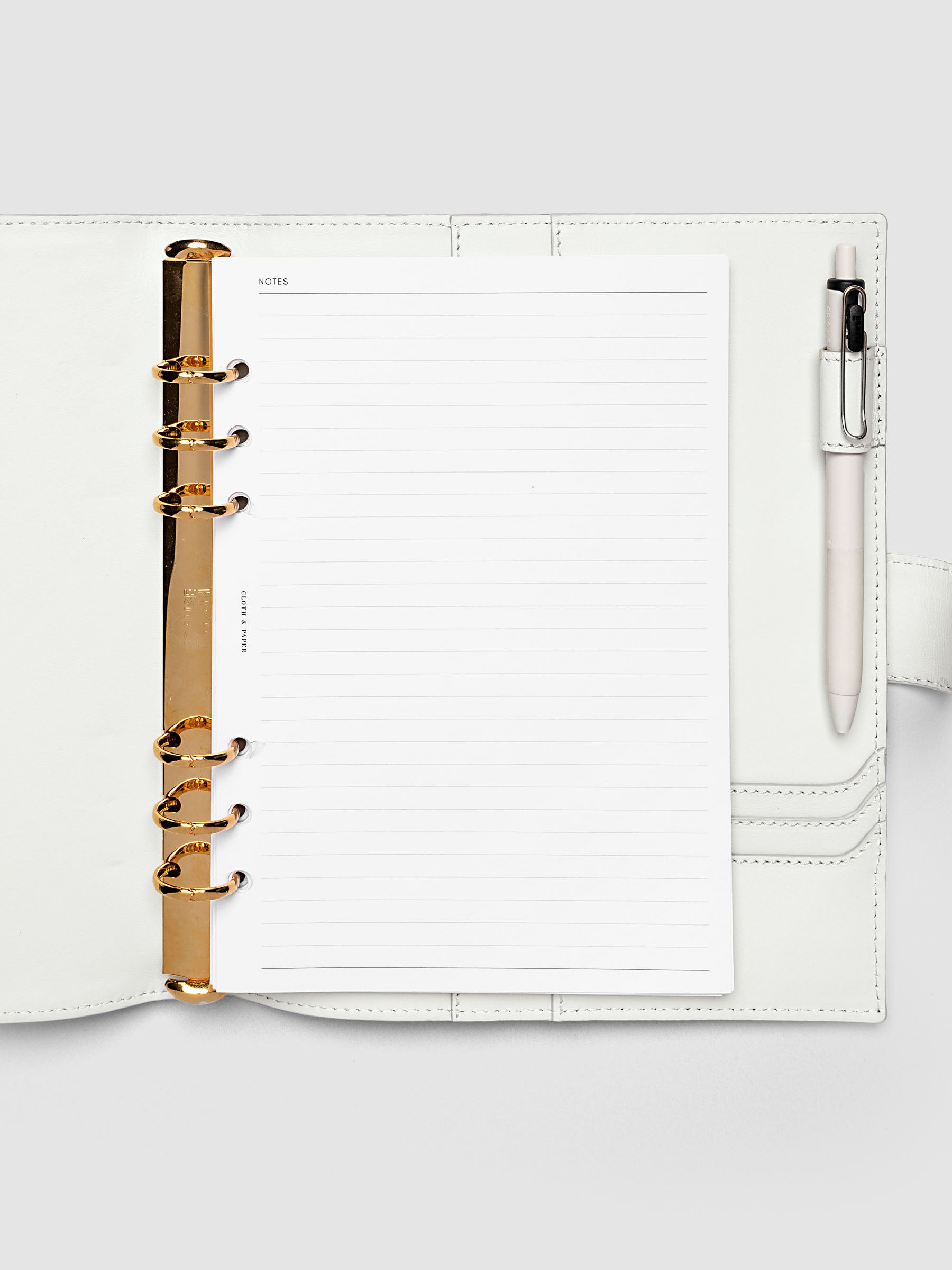Open off-white genuine leather A5 6-ring planner cover with inserts inside, gold Krause rings visible