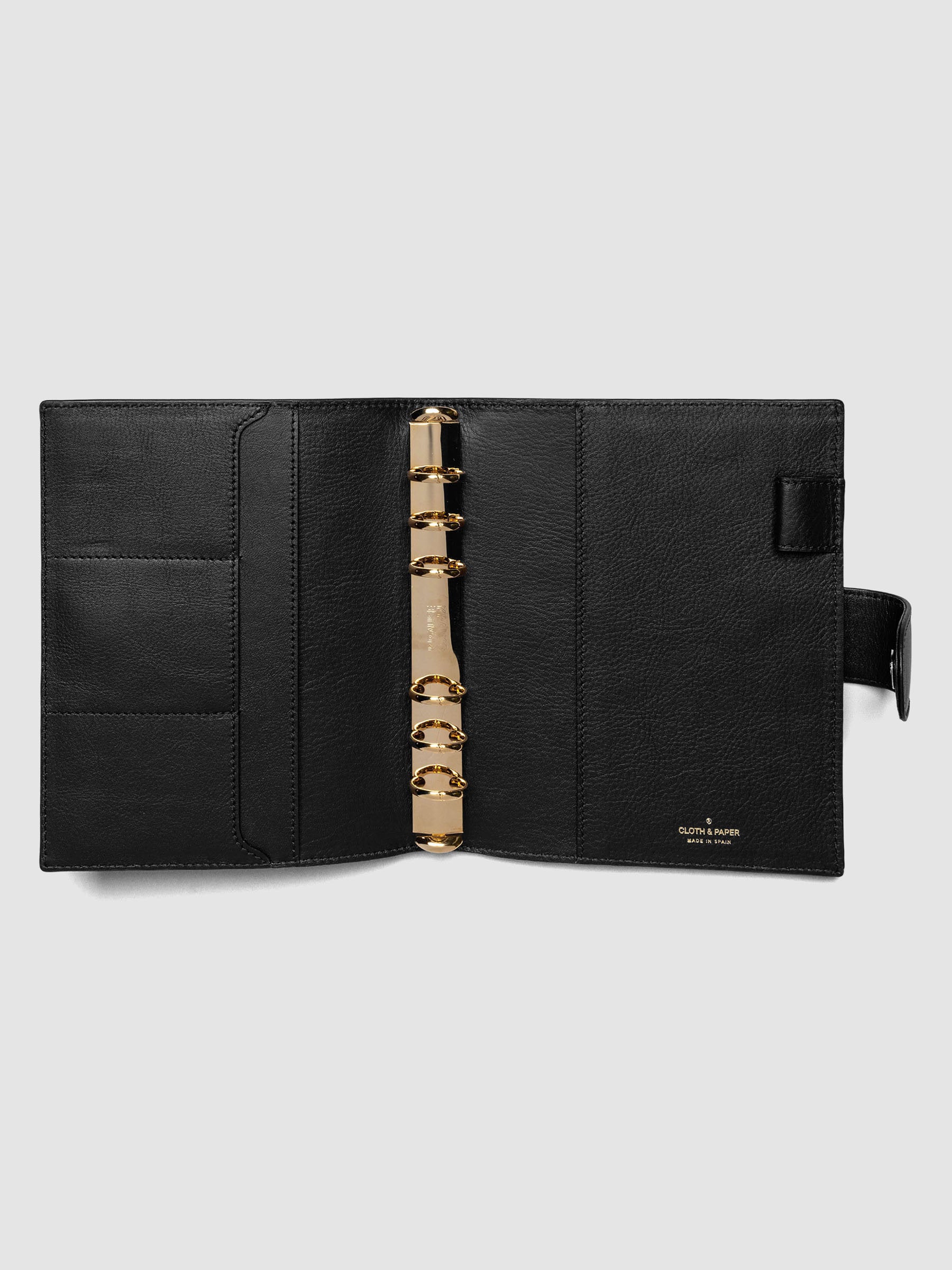 Open black genuine leather Personal Wide 6-ring planner cover showing full interior, gold Krause rings and pockets visible on both sides