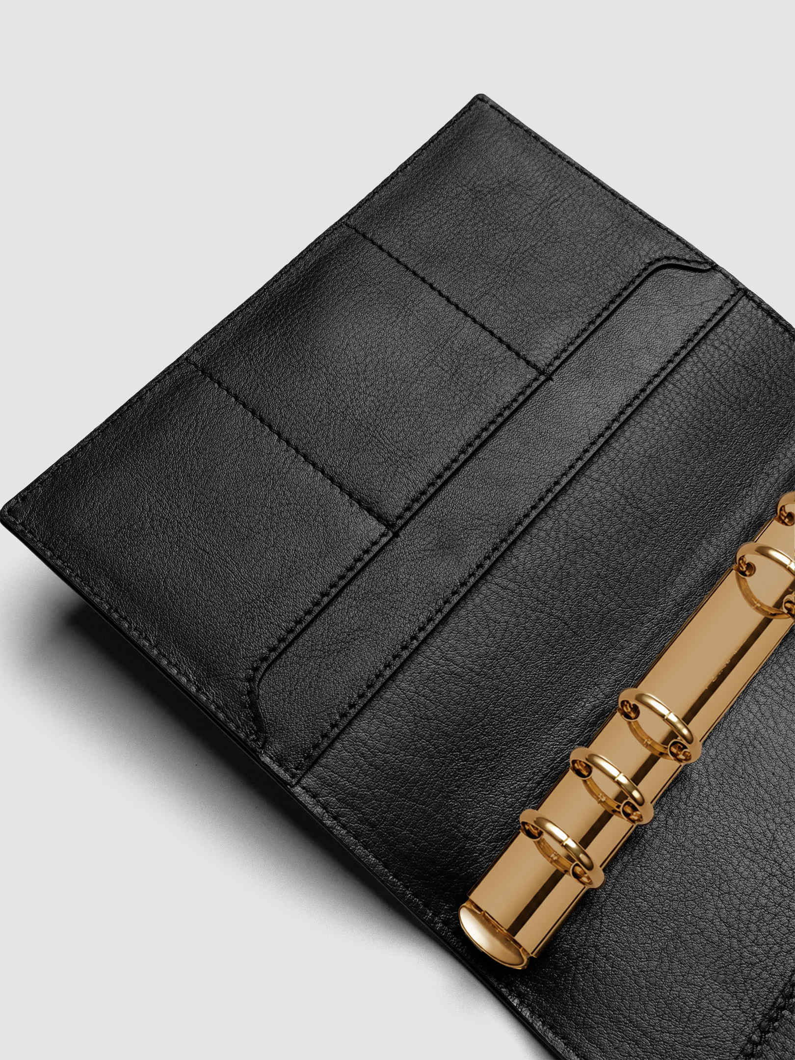 Detail of large interior pocket on the left side of a black genuine leather Personal Wide 6-ring planner cover