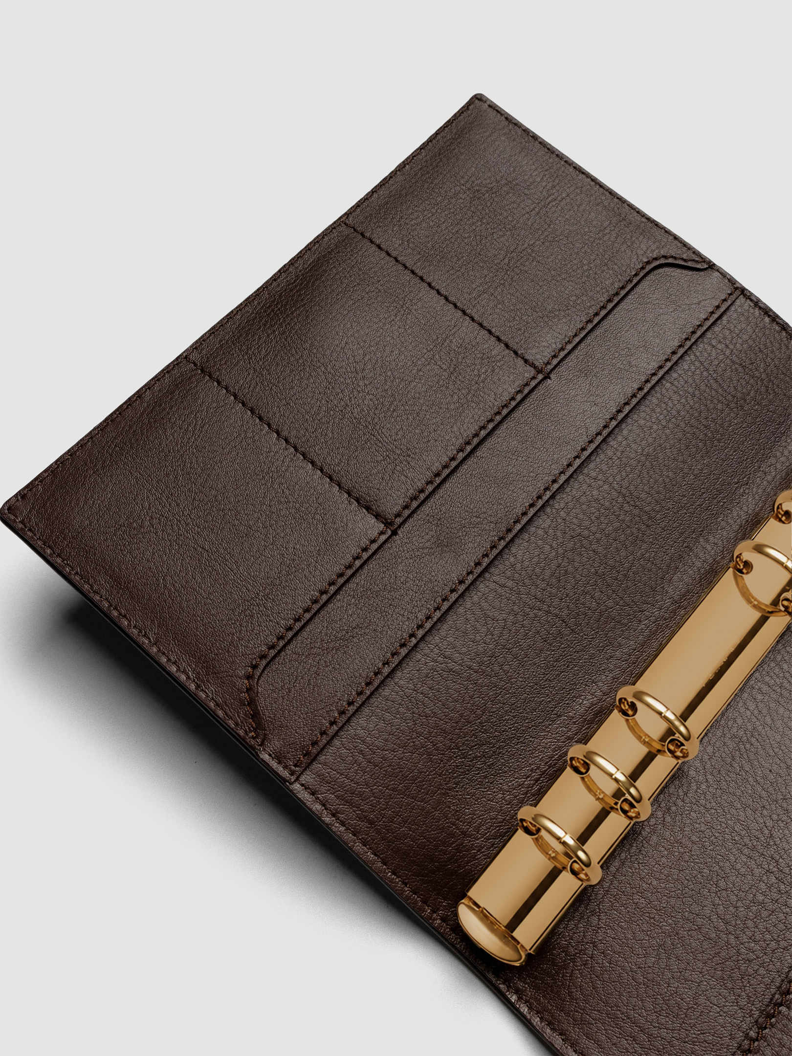 Detail of large interior pocket on the left side of a dark brown genuine leather Personal Wide 6-ring planner cover