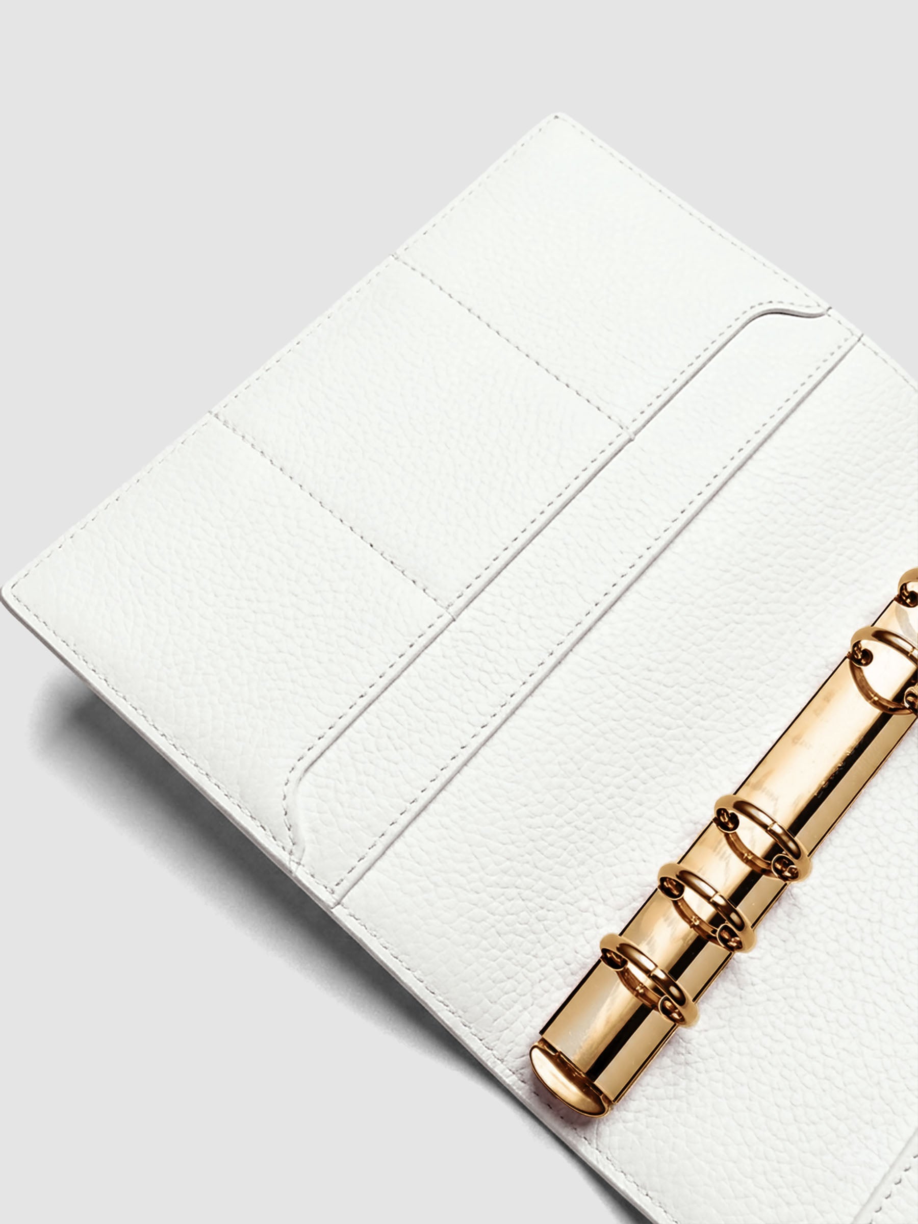 Detail of large interior pocket on the left side of an off-white genuine leather Personal Wide 6-ring planner cover