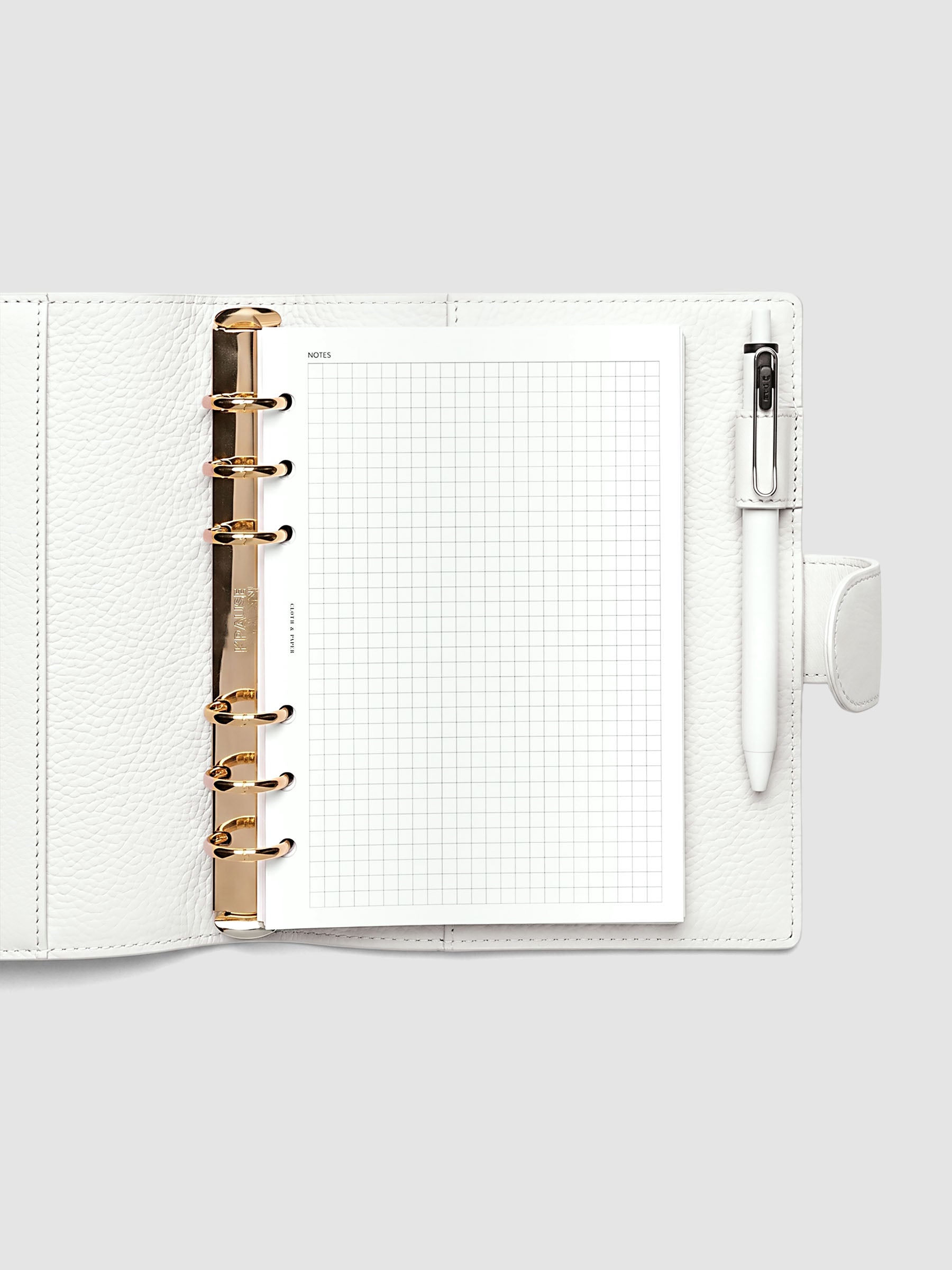 Open off-white genuine leather Personal Wide 6-ring planner cover with inserts inside, gold Krause rings visible