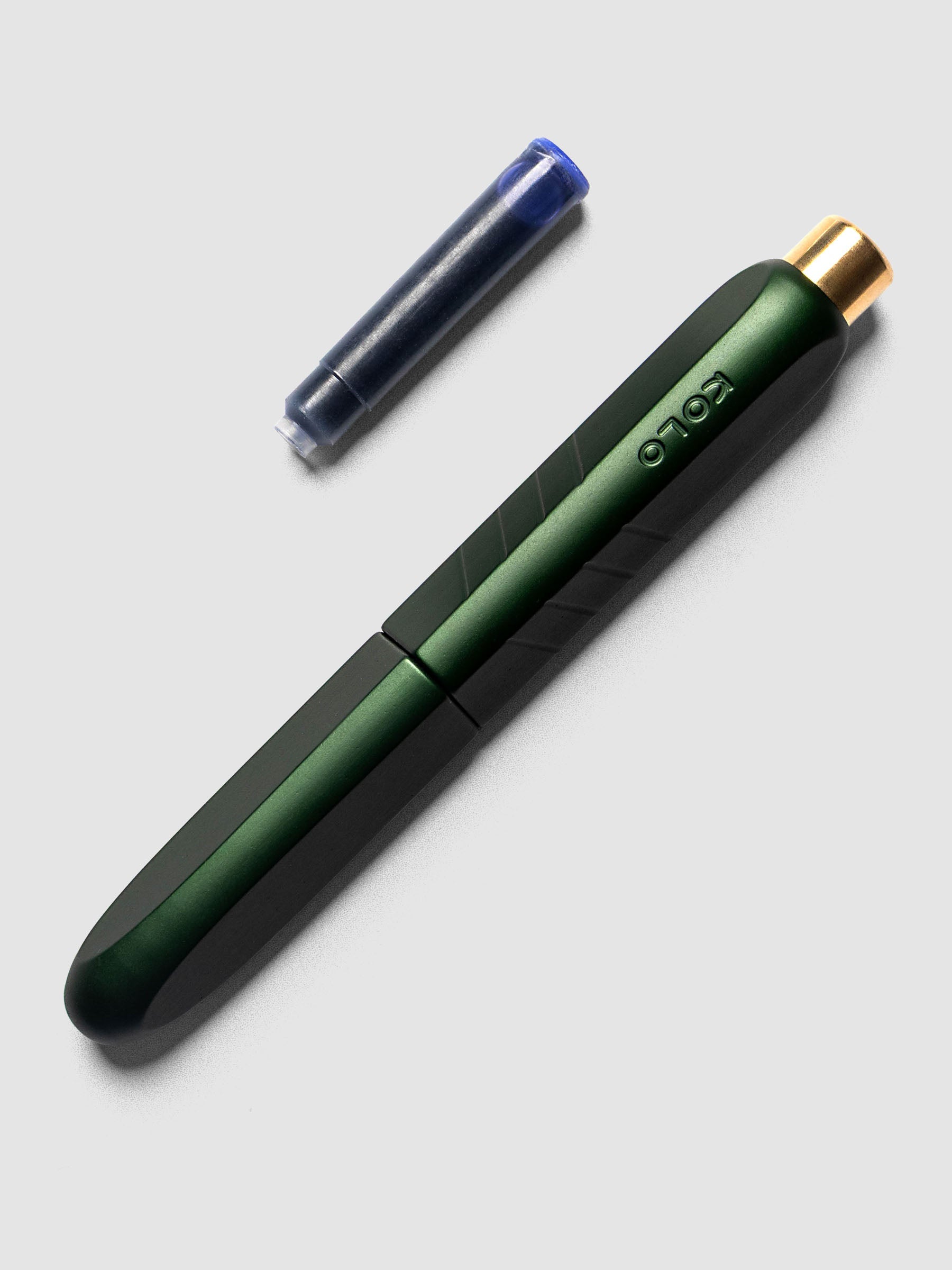 Kolo Tino Fountain Pen in Anodized Aluminum Verdant shown cap on with ink cartridge resting beside pen