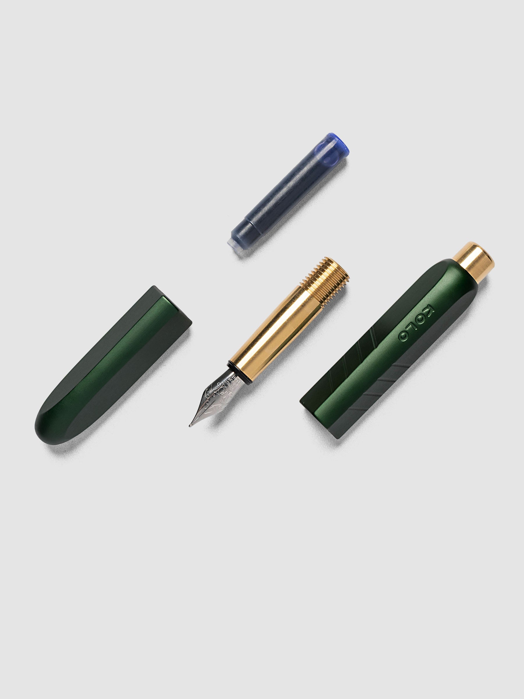 Kolo Tino Fountain Pen in Anodized Aluminum Verdant fully disassembled showing cap, nib section, barrel, and ink cartridge
