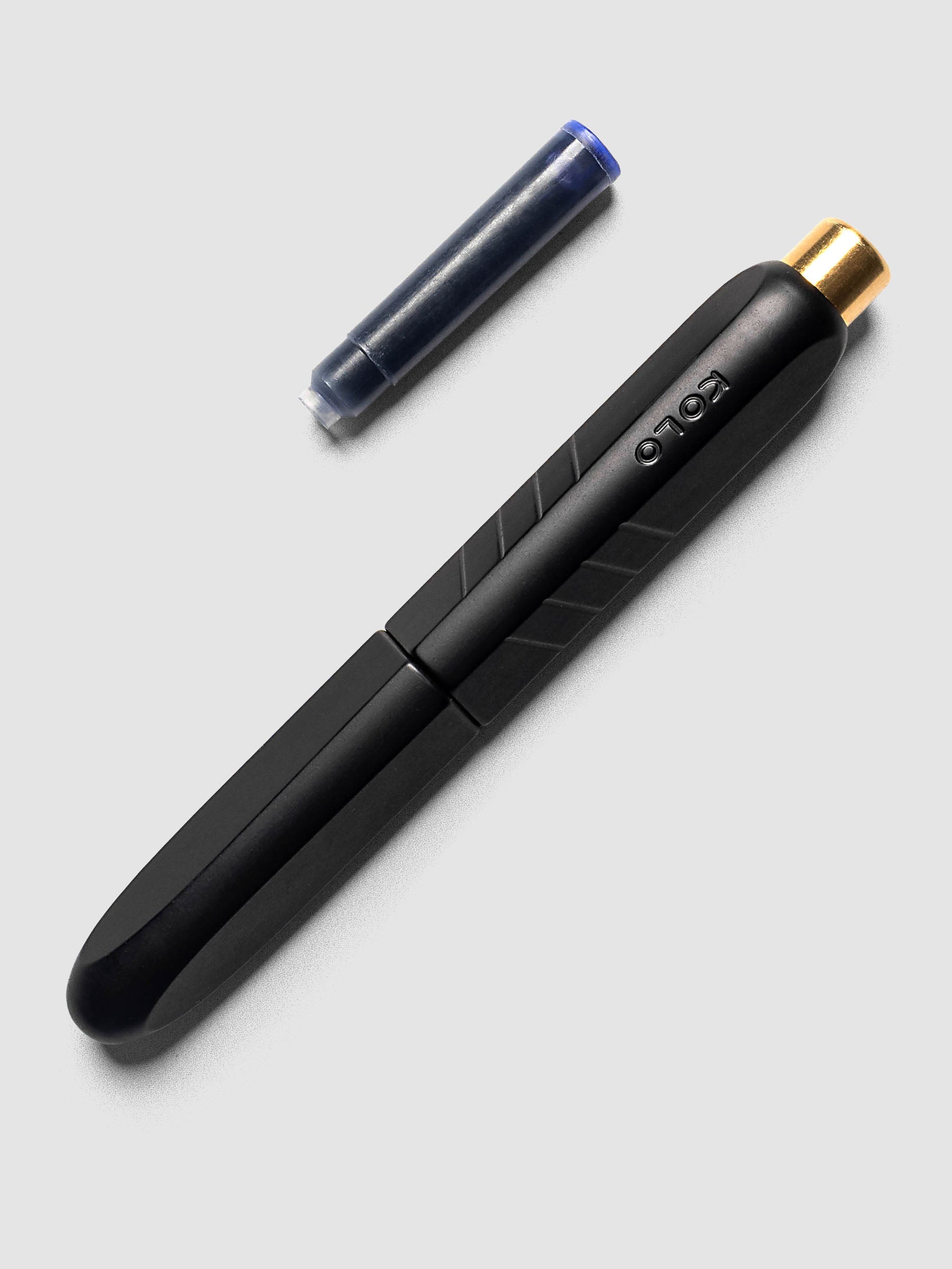Kolo Tino Fountain Pen in Anodized Aluminum Noir shown cap on with ink cartridge resting beside pen