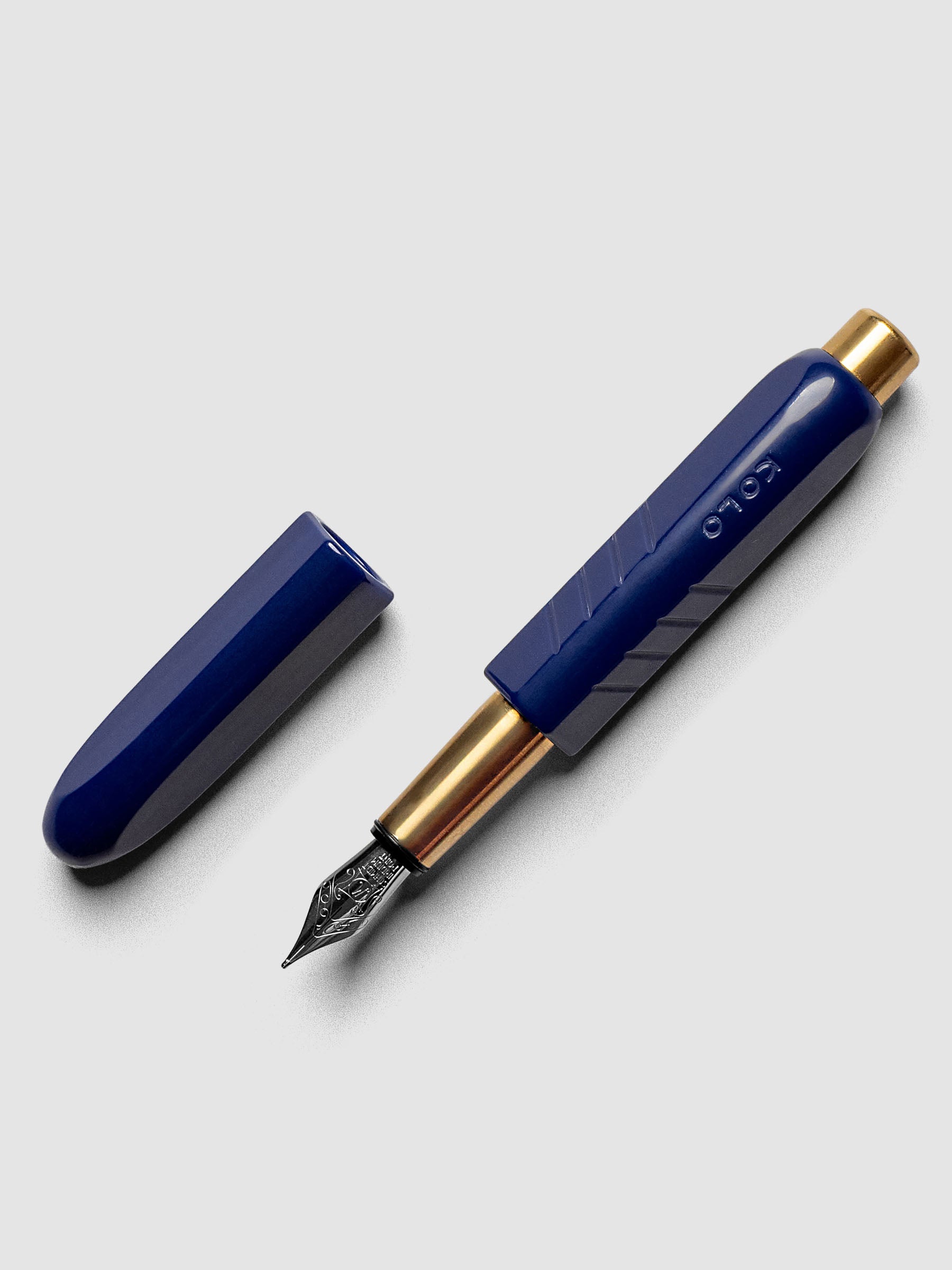 Kolo Tino Fountain Pen in the color Acrylic Albert Blue, a cobalt barrel with brass accents and a silver medium nib shown with cap off.