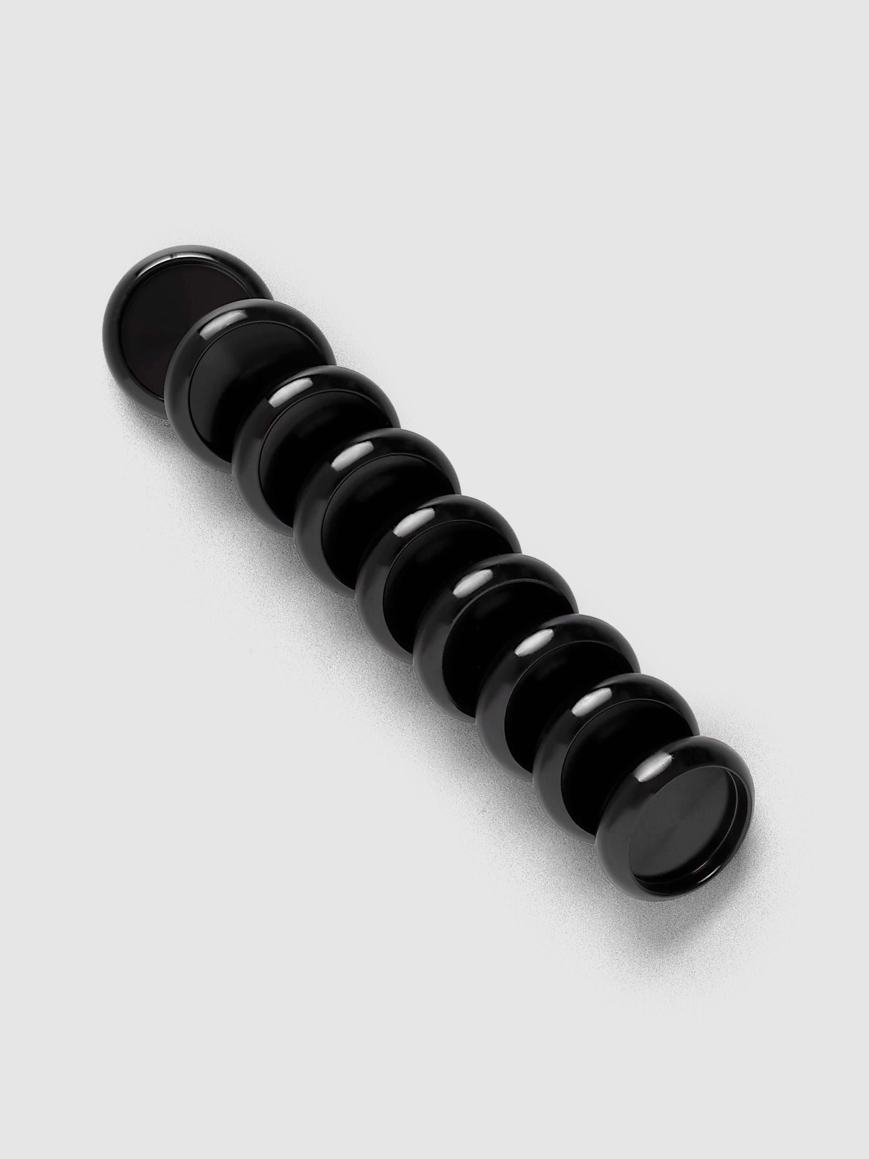 Aluminum Planner Discs | Black, 0.75 Inch, set of nine arranged in a diagonal line on a neutral background