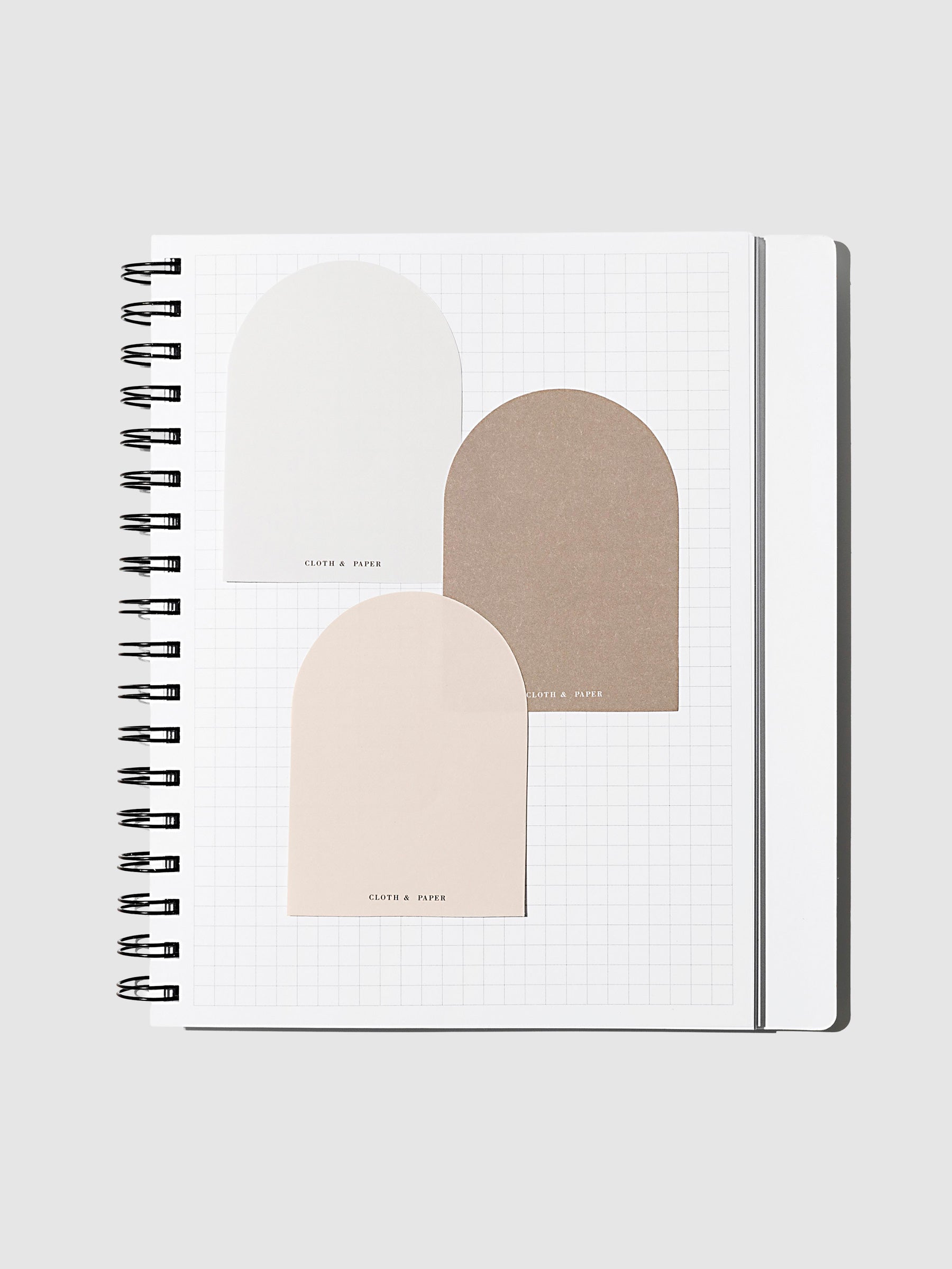 Angora, Beignet, and Cortado sticky notes layered over each other inside of a graph notebook on a neutral background.