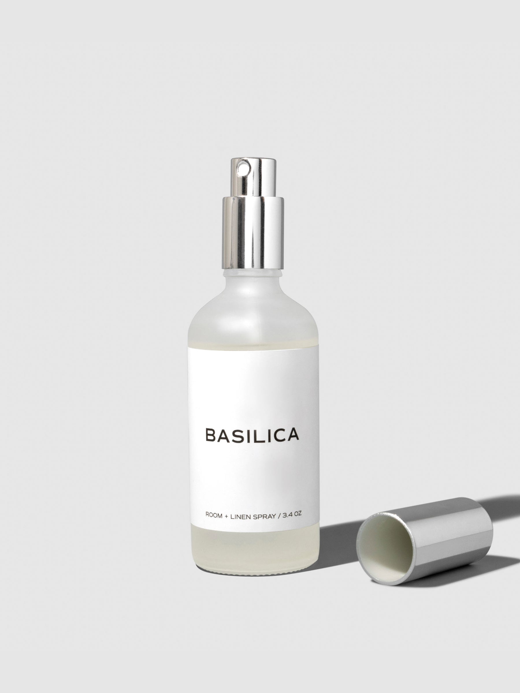 Basilica Room Spray, Cloth and Paper. Spray shown on a neutral background.