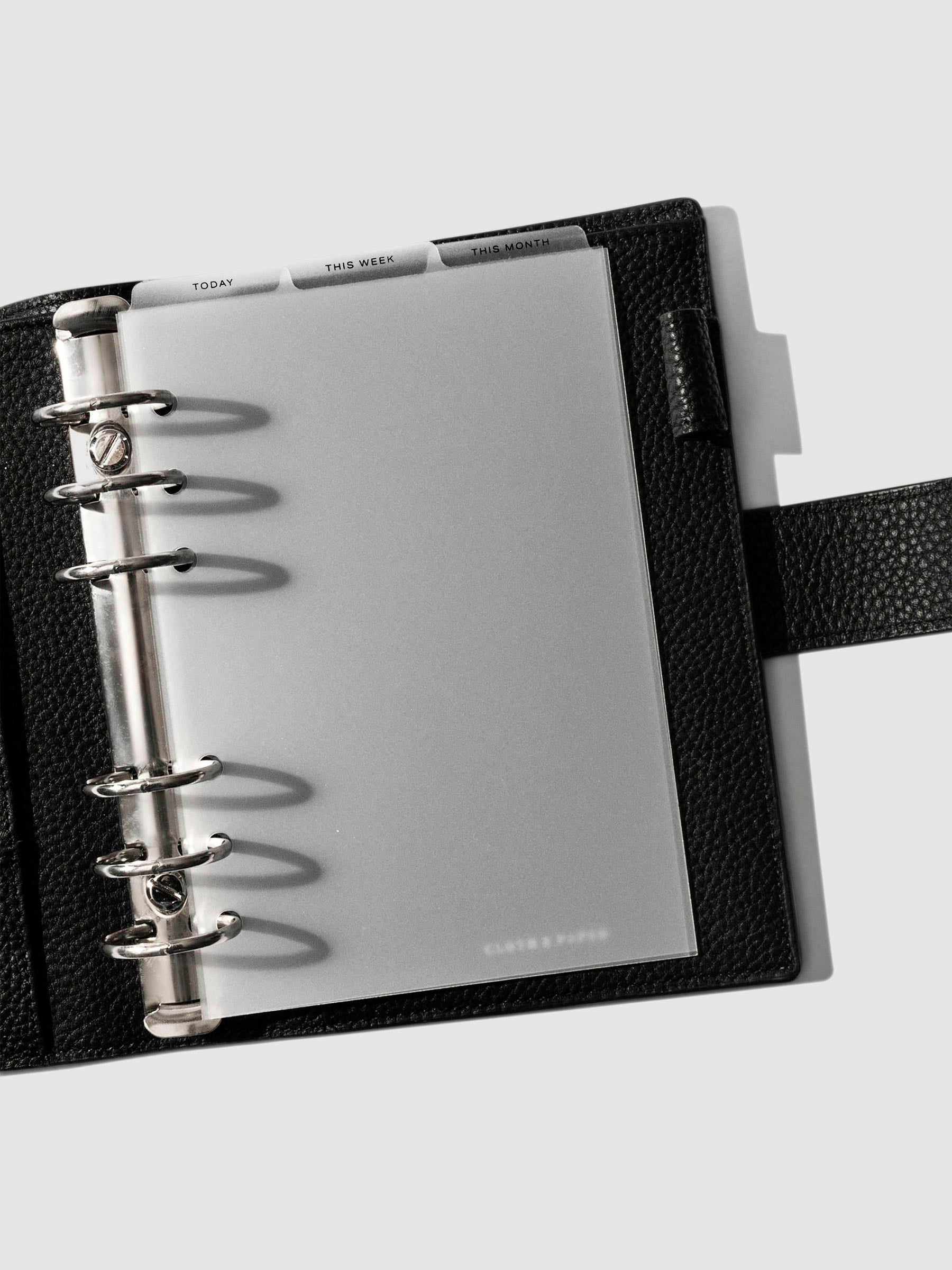 Personal Wide Black Foil Cadence Tab Dividers displayed in a black leather planner.