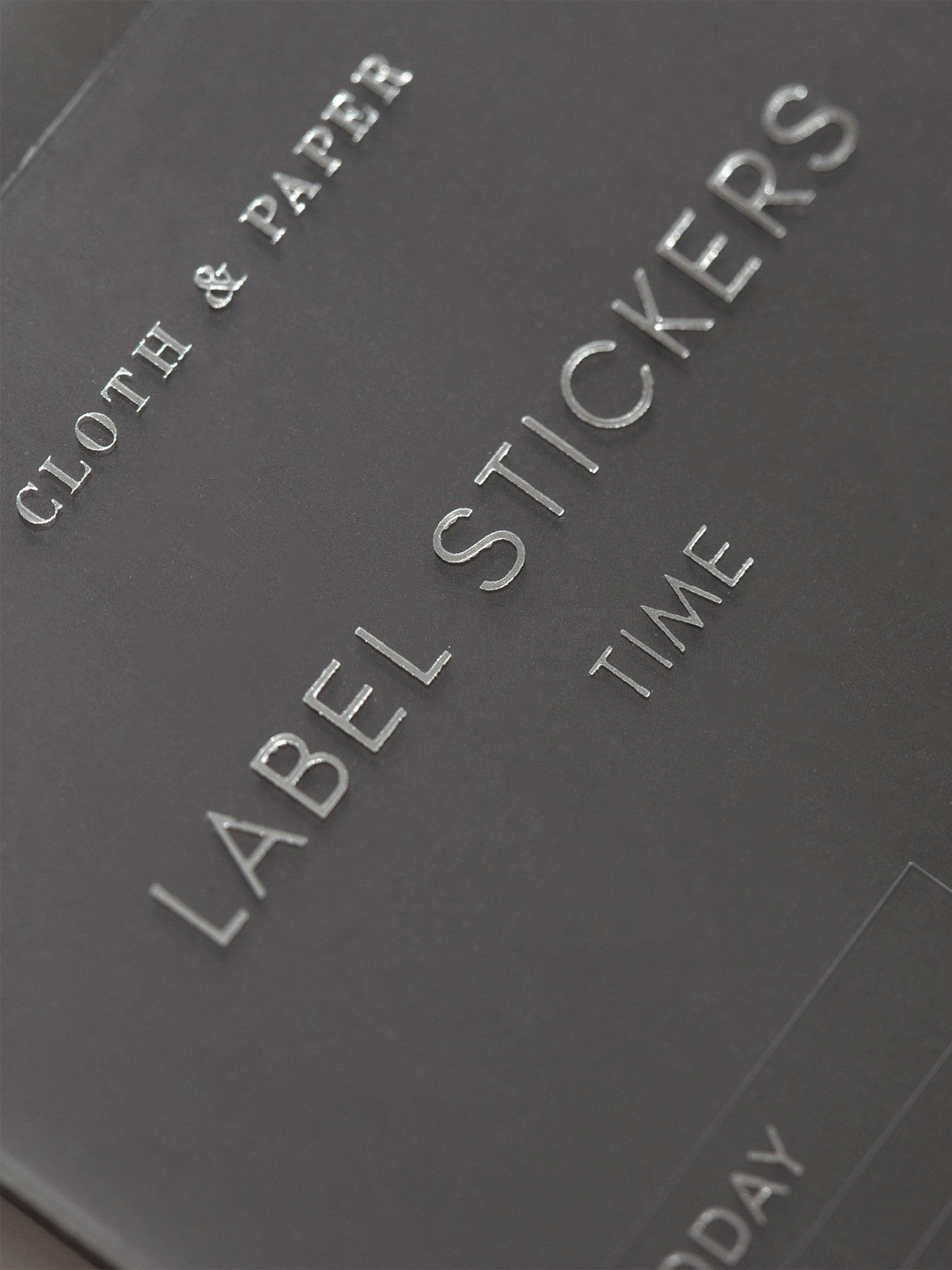 Zoomed in photo of the Clear Label Stickers spotlighting the title of the sticker sheet that says Label Stickers Time