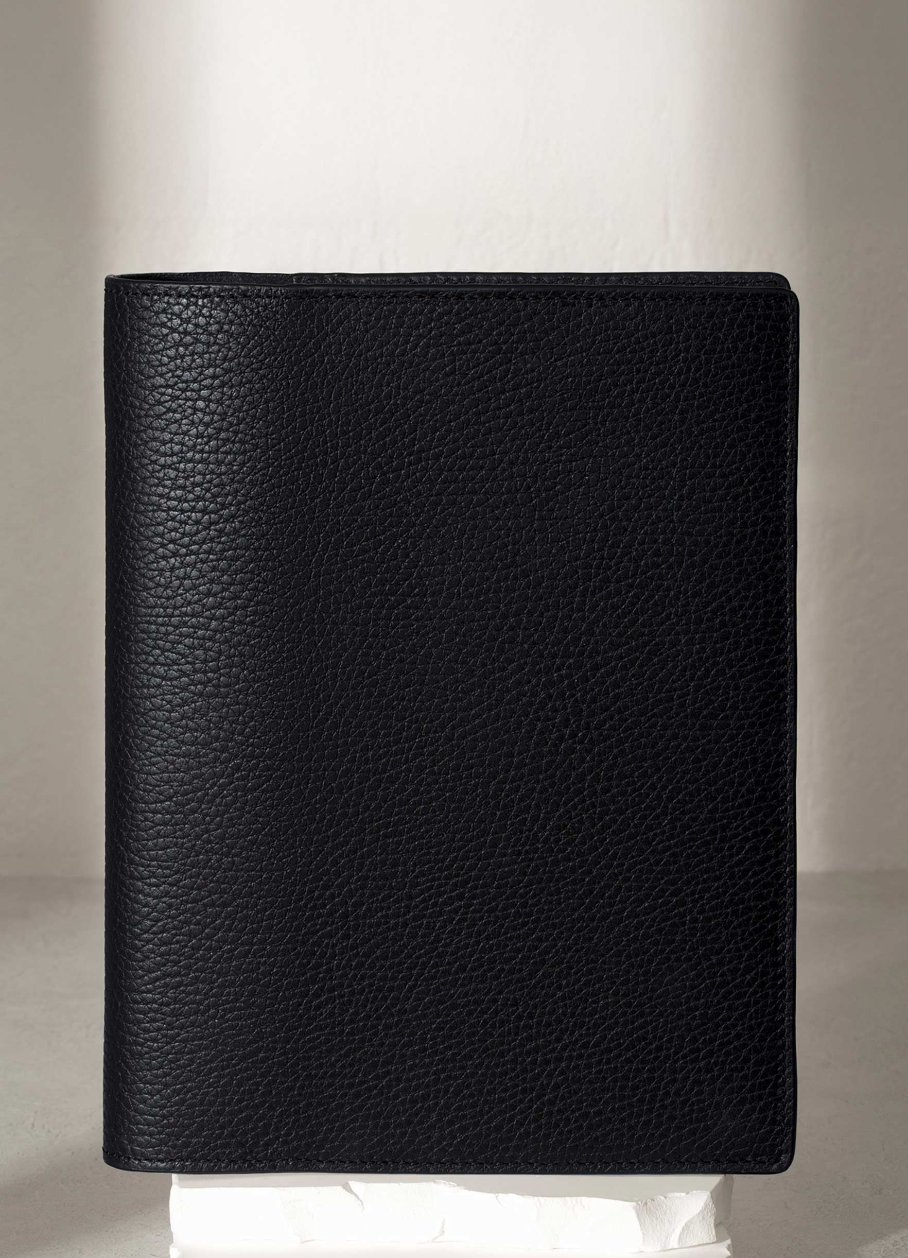 Padrillo folio displayed on a white pedestal.