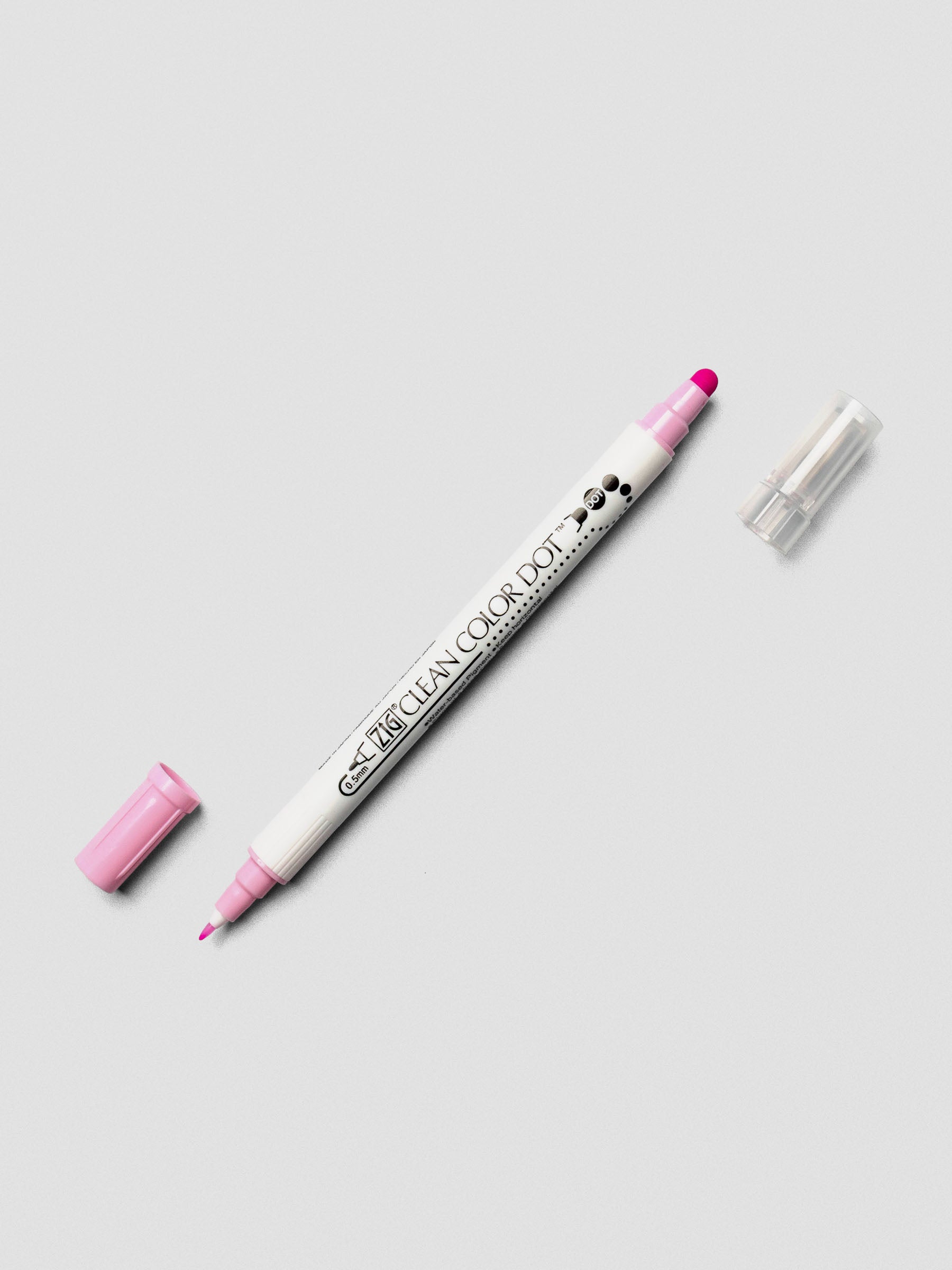Candy Pink Kuretake ZIG Clean Color Dot Dual Tip Marker with caps off, displaying both the fine tip and dot tip on a light background.