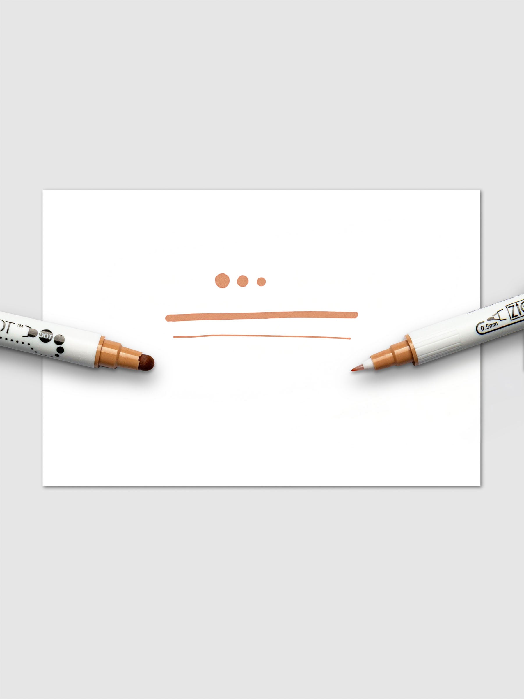 Demonstration of the Fawn marker's ink with dots and lines on white paper, highlighting the pressure-sensitive versatility of the dual tips.