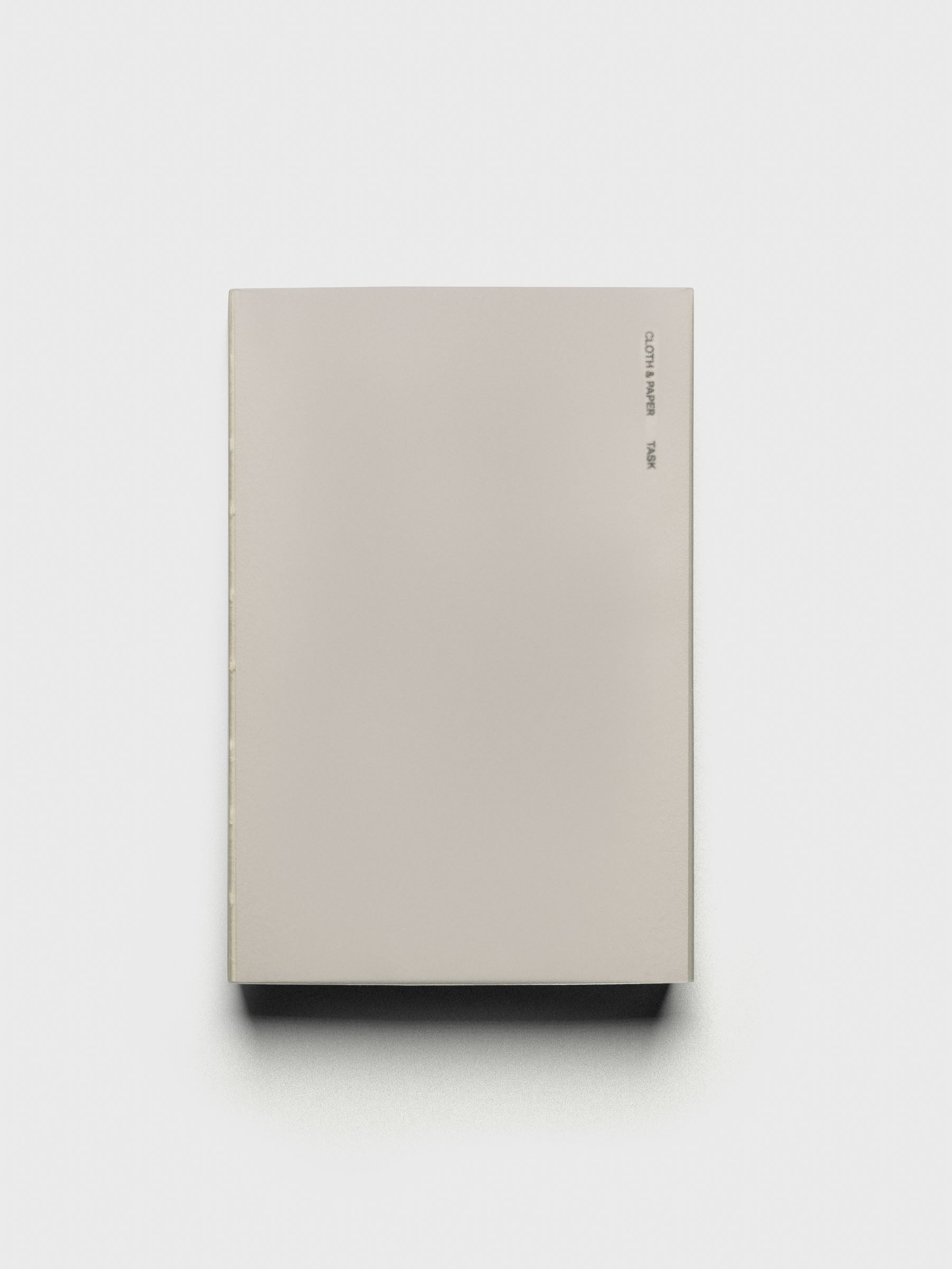 Perfect Bound Notebook | CP Petite | Task | Ristretto shown closed, laying flat, on a neutral background.