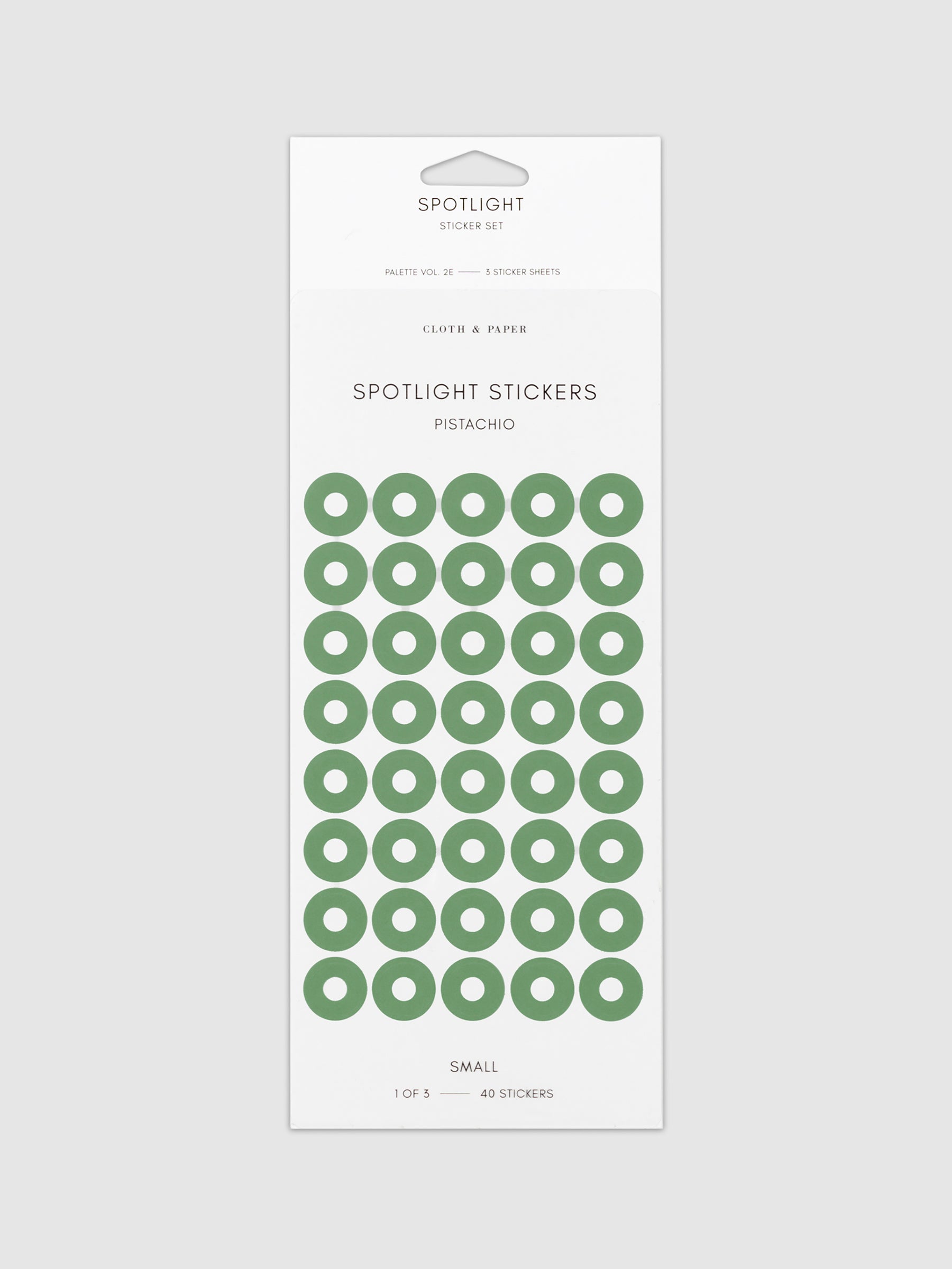 Small sticker in its packaging displayed on a neutral background. Pictured color is pistachio.